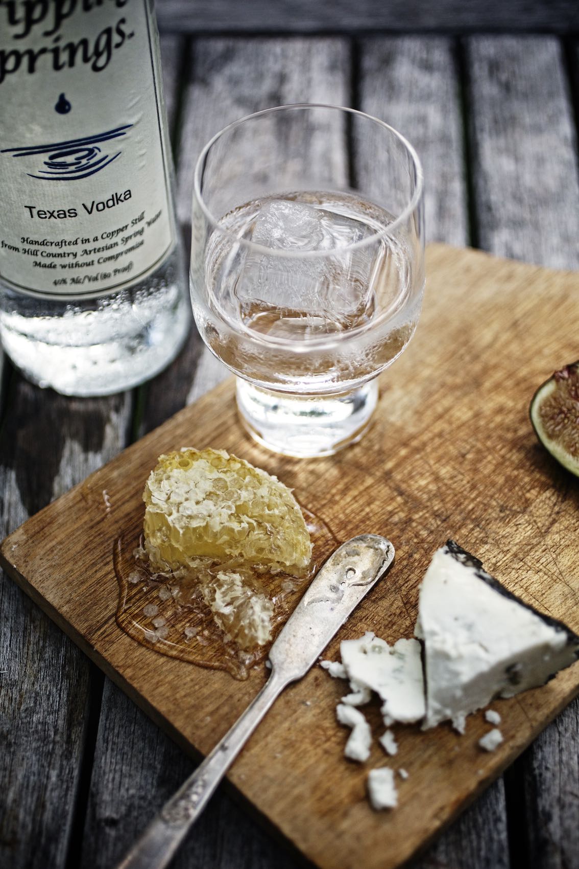 Jody Horton Photography - Dripping Springs Vodka with ice on cutting board with cheese spread.