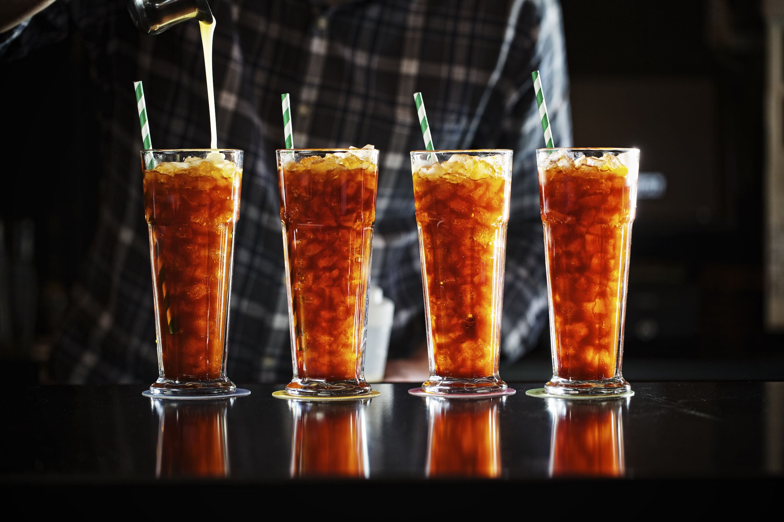 Jody Horton Photography - Thai ice teas in a row with striped straws. 