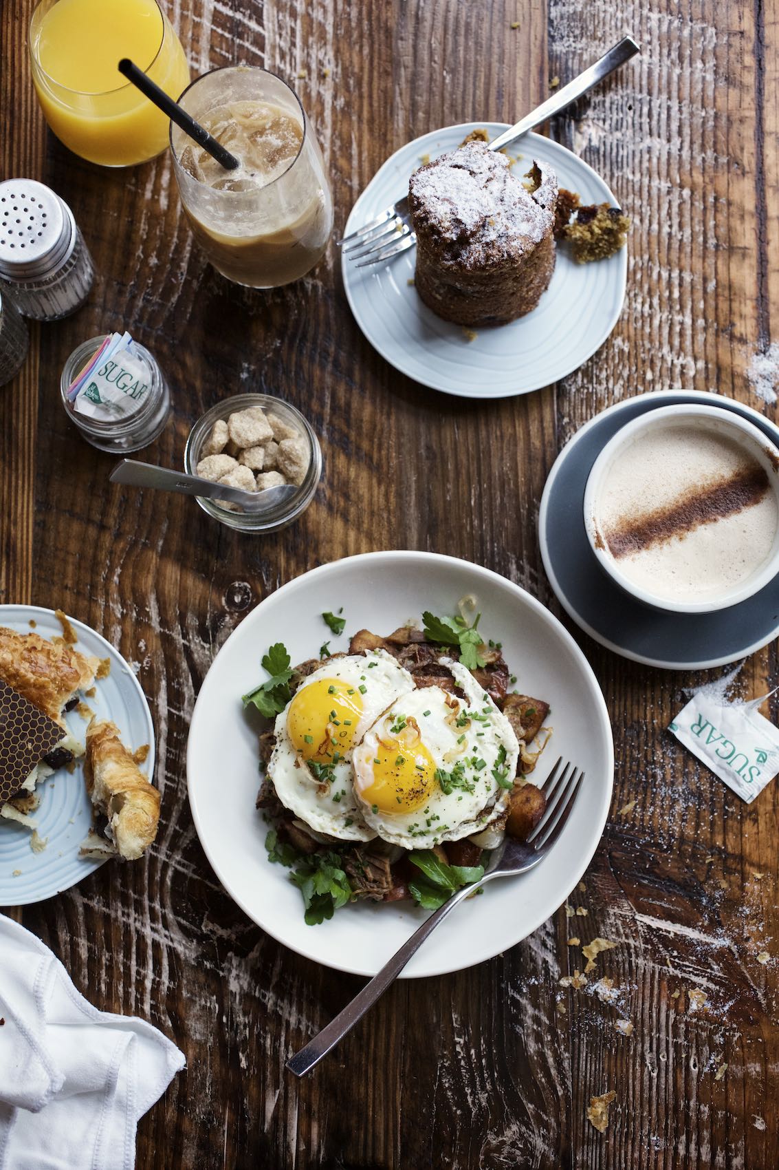 Jody Horton Photography - Breakfast spread and coffees on a wooden table.