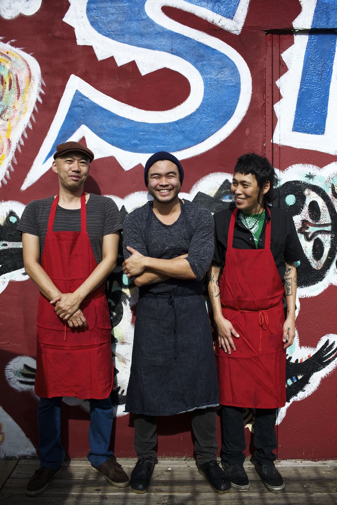 Jody Horton Photography - Three chefs standing against colorfully painted wall.