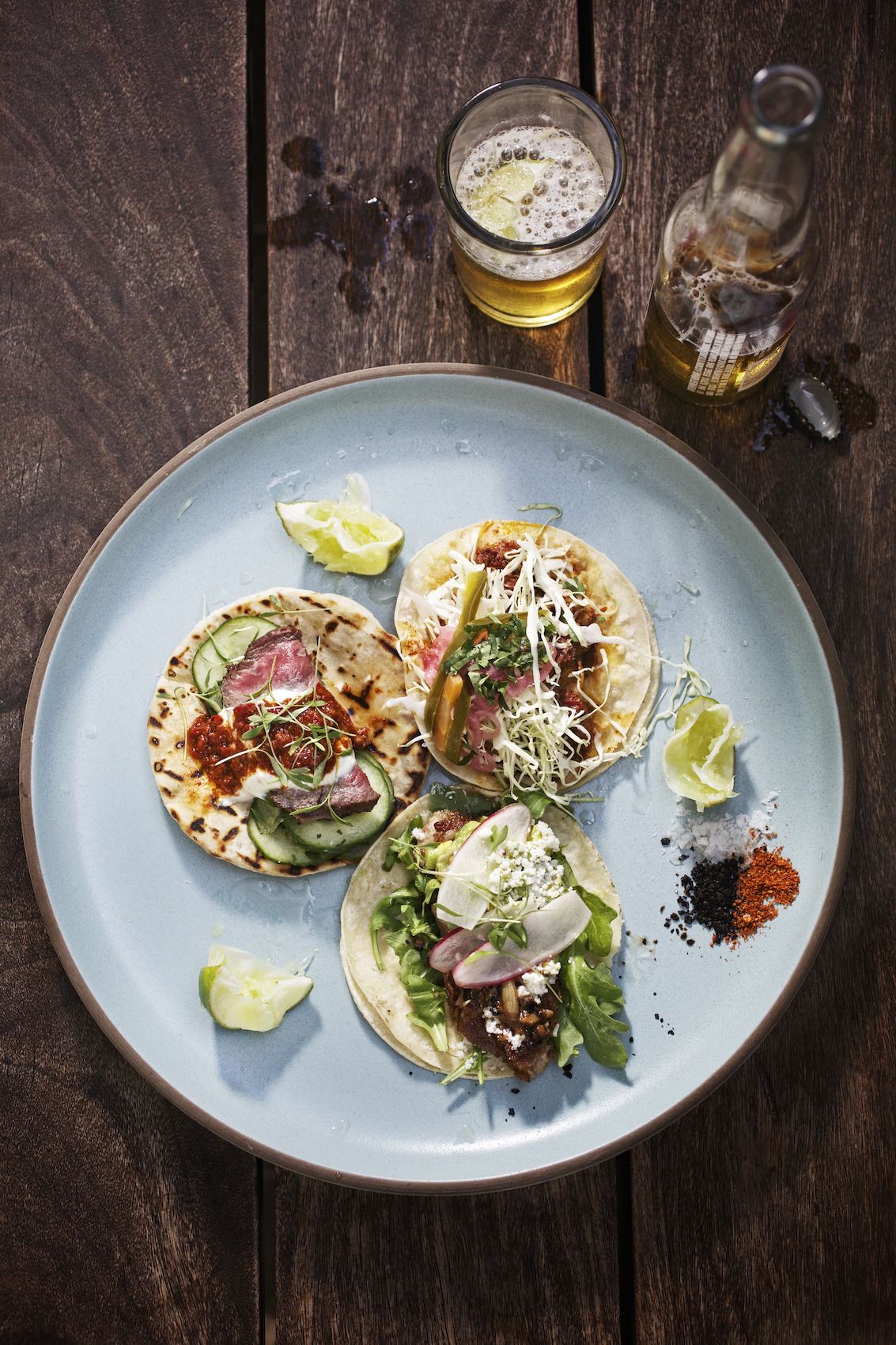 Jody Horton Photography - Three tacos on light blue plate with bottled beer. 