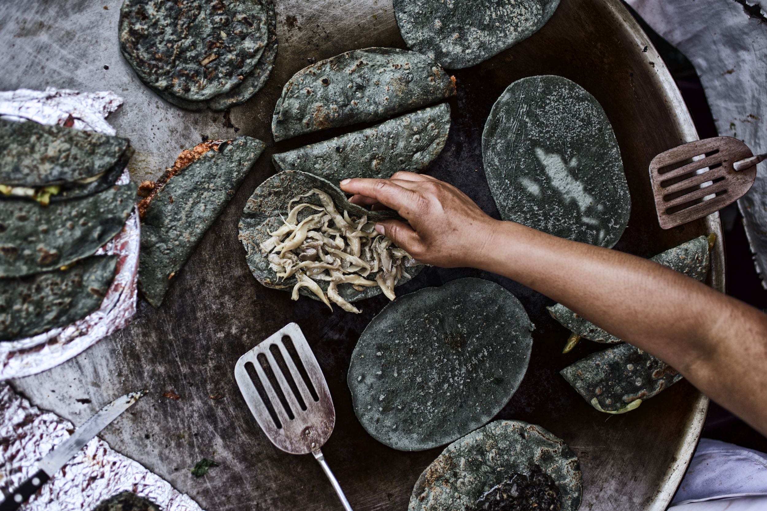 Jody Horton Photography - Cooking blue corn tortillas on flattop. 