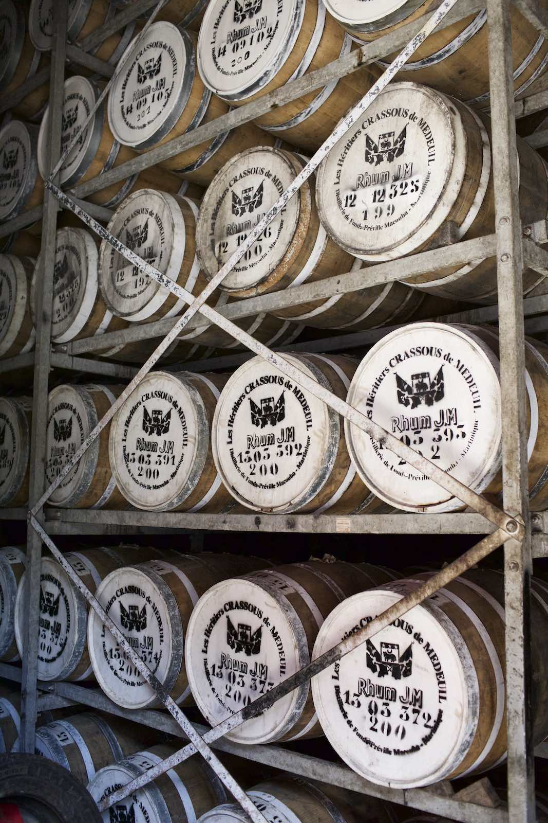 Jody Horton Photography - Wood barrels of rum stored on metal shelves. 