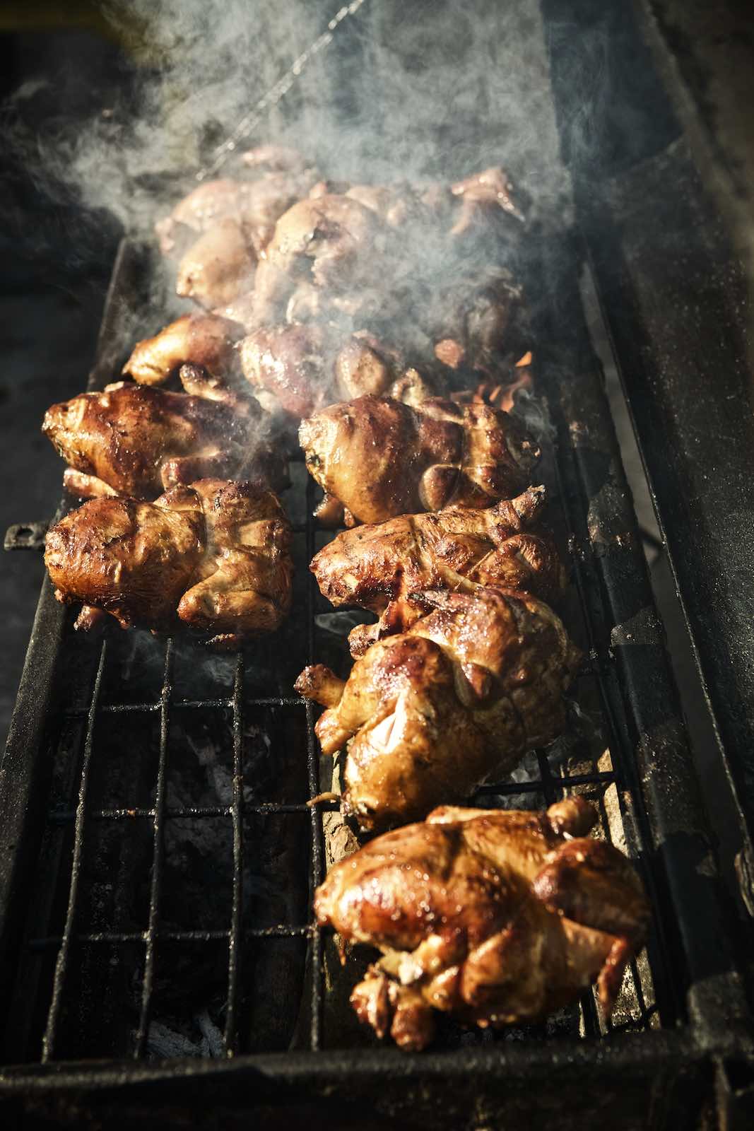 Jody Horton Photography - Chickens cooking on a smokey grill. 