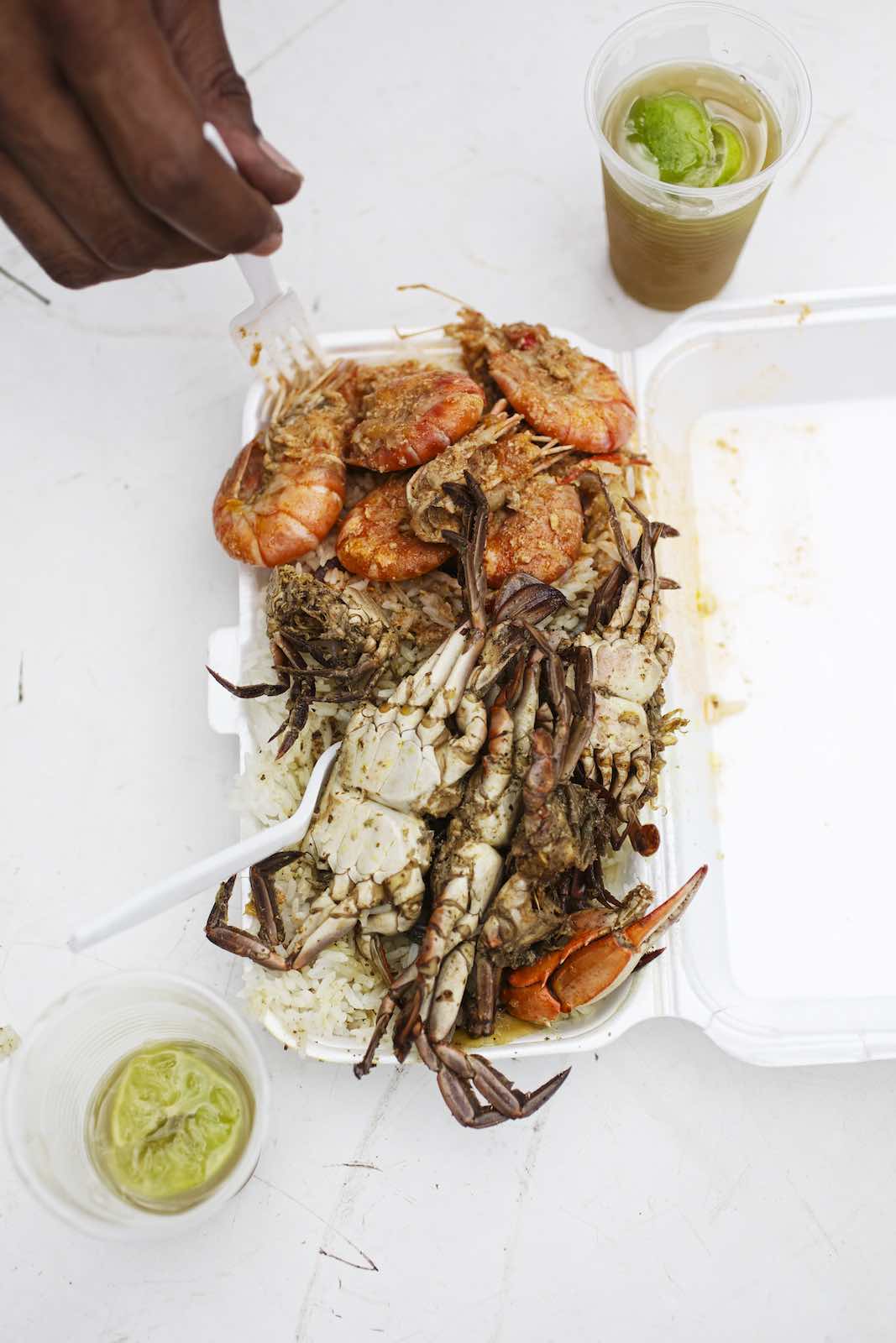 Jody Horton Photography - Rice and seafood in a white container served with cold drinks. 