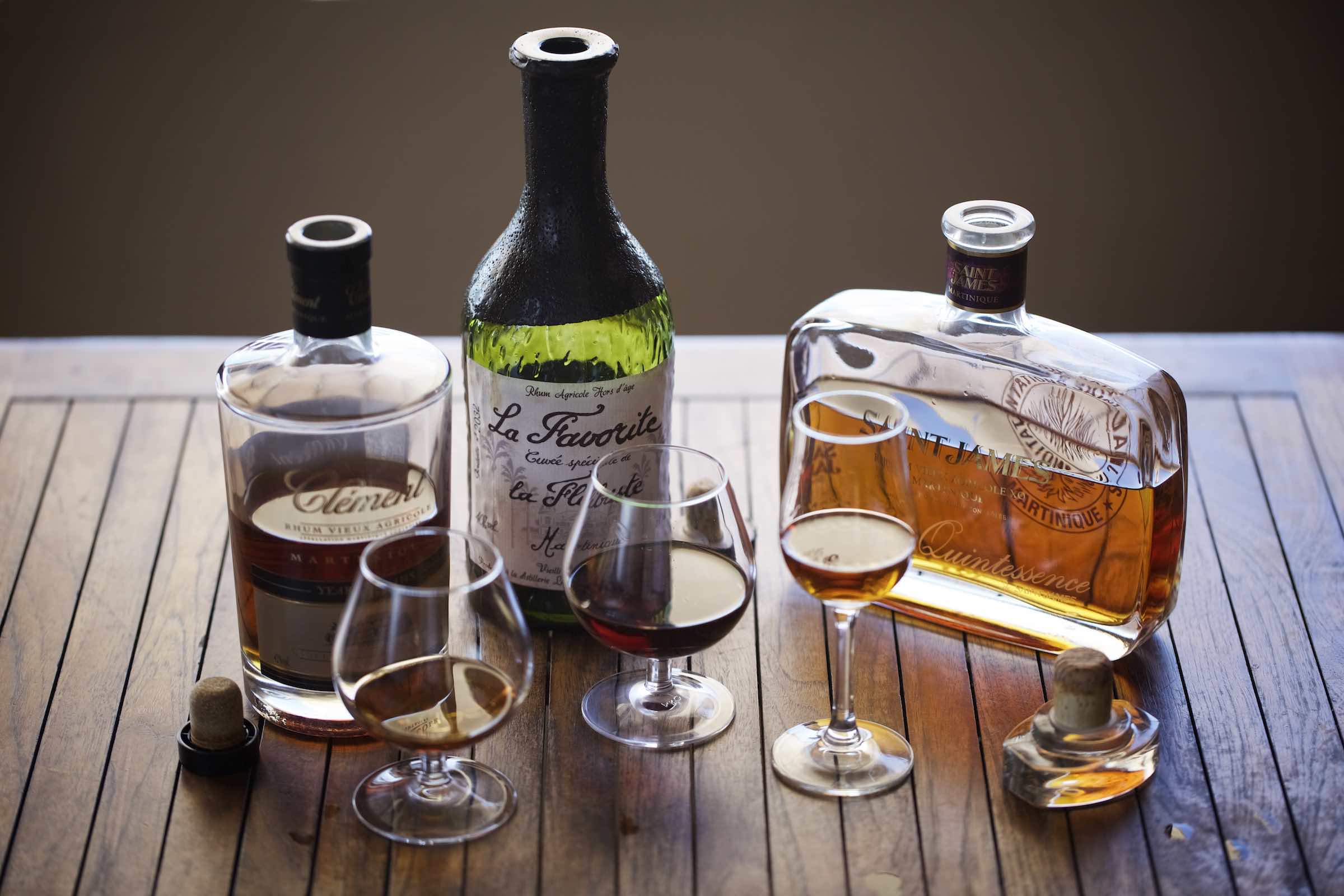 Jody Horton Photography - Assorted rum bottles with each rum poured in a stemware glass. 