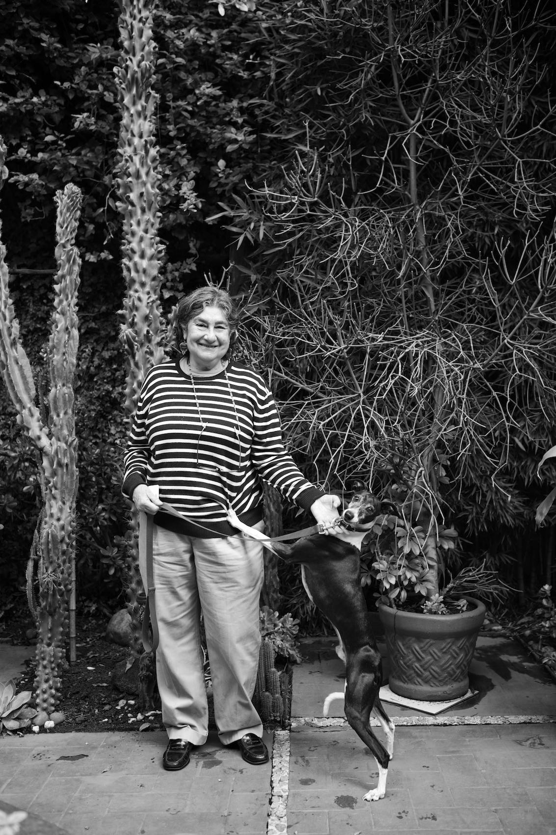 Jody Horton Photography - Woman and her dog posing against greenery, shot in B&W.