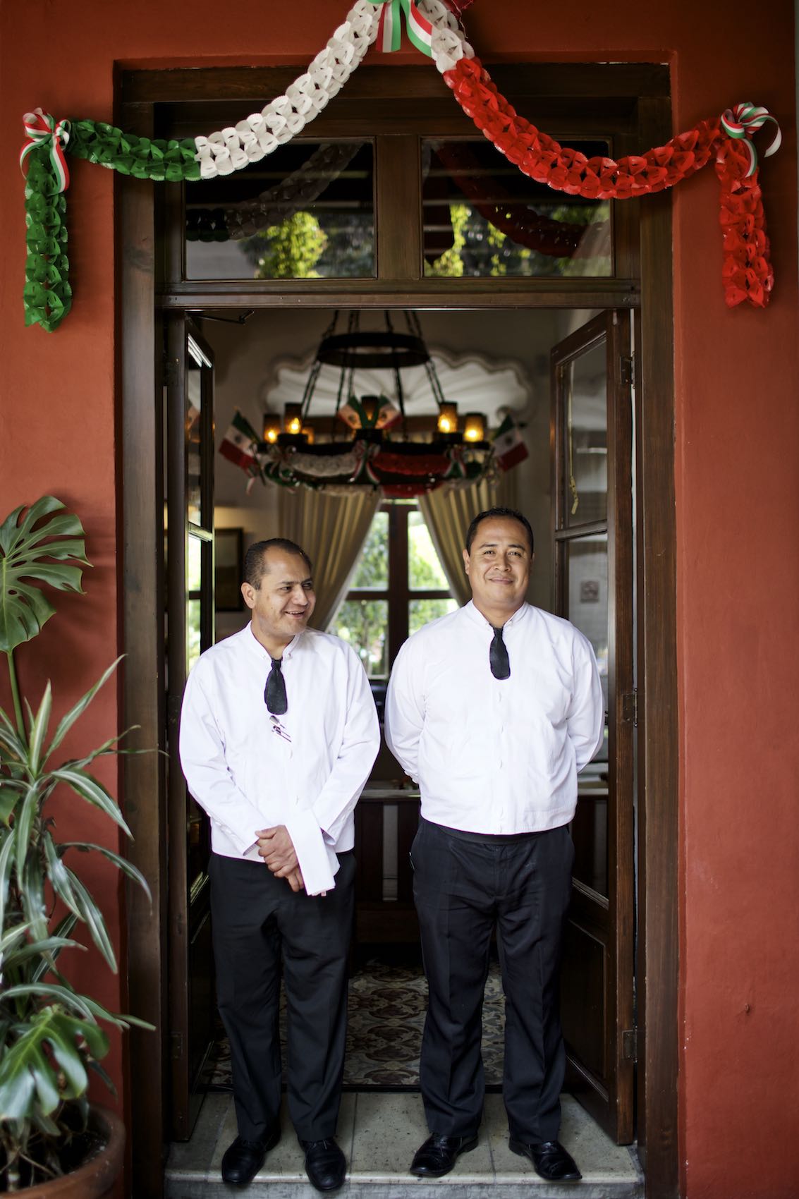 Jody Horton Photography - Servers in uniform standing in the doorway of a restaurant 
