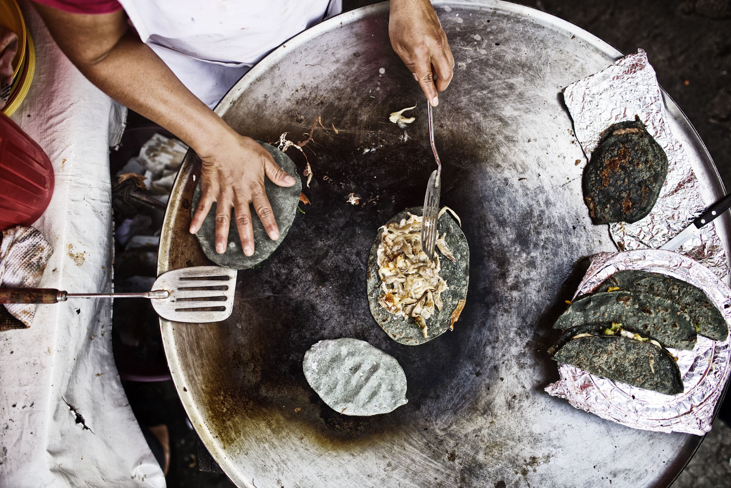 Jody Horton Photography - Tacos being prepared on a plancha. 
