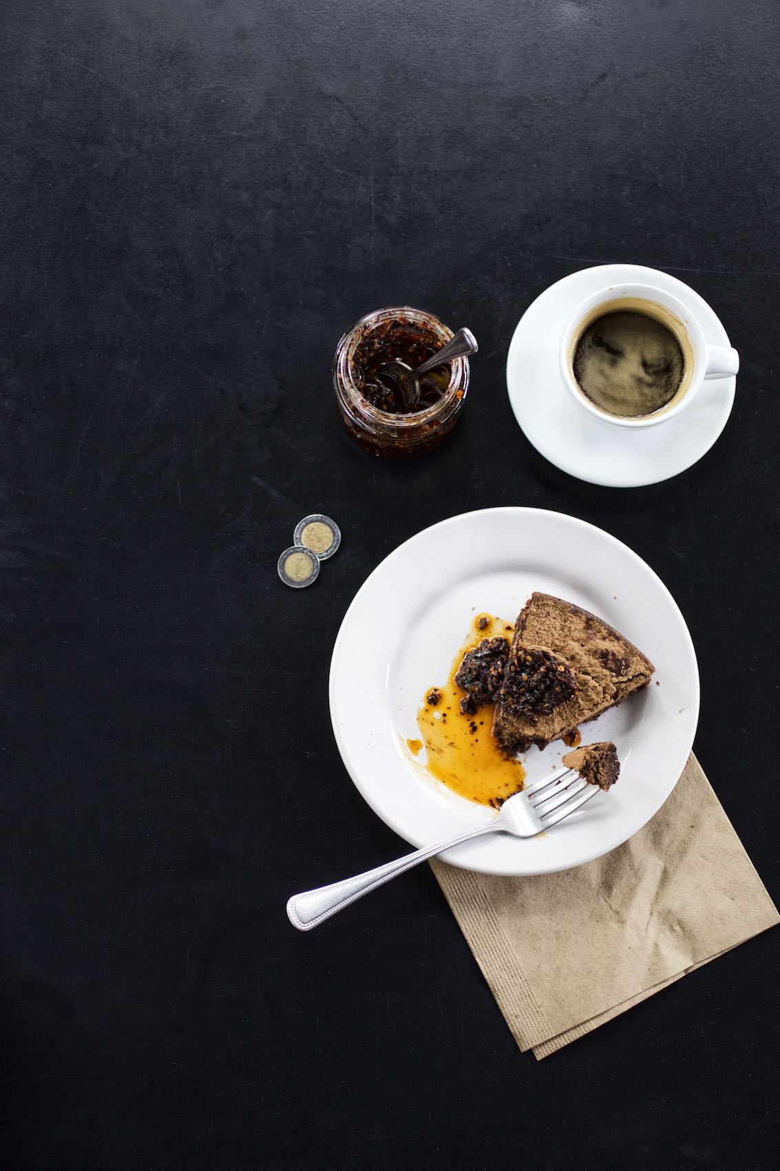 Jody Horton Photography - Cafe snack, espresso, and pesos on a black table. 