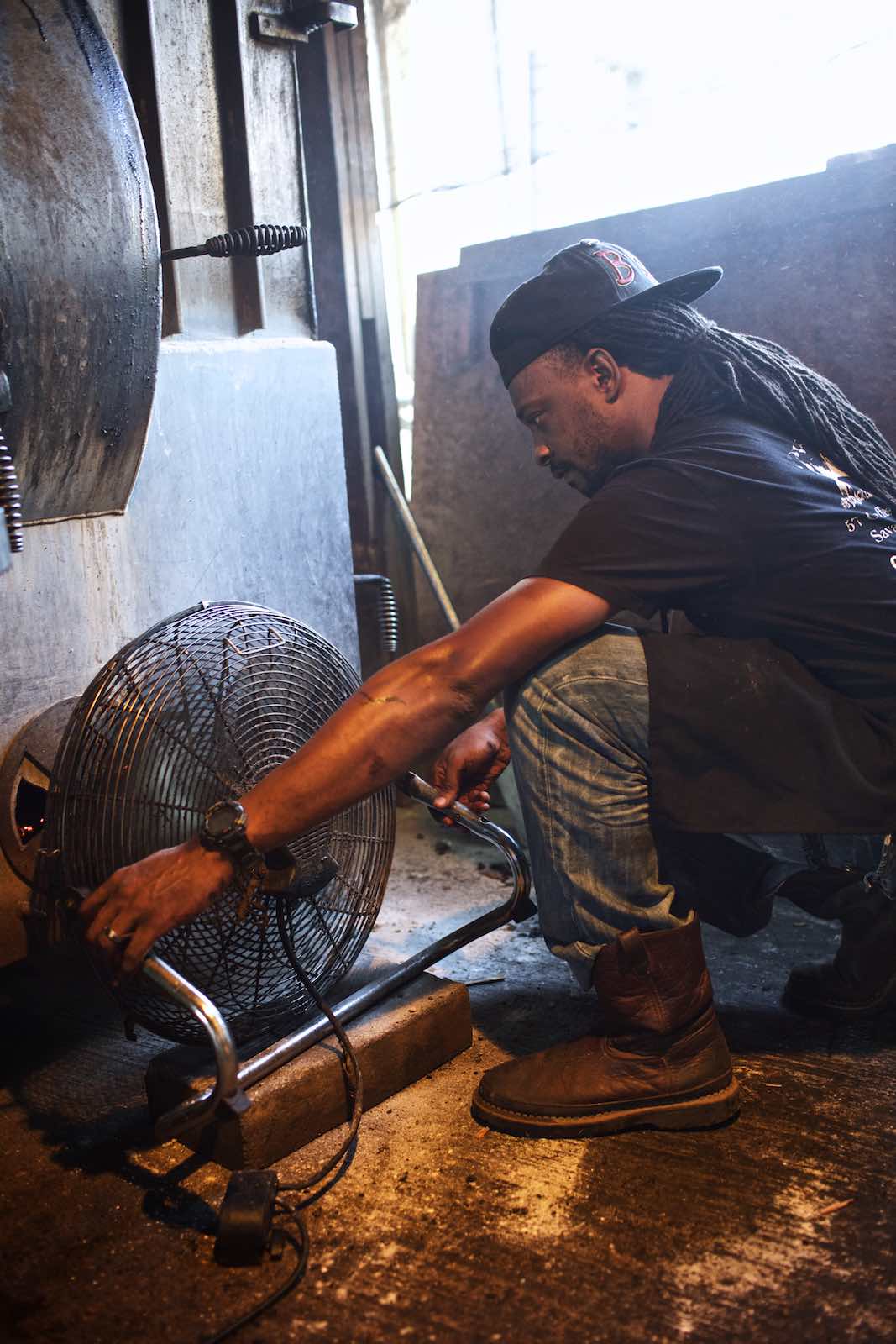 Jody Horton Photography - Chef adjusting fan in an open kitchen. 