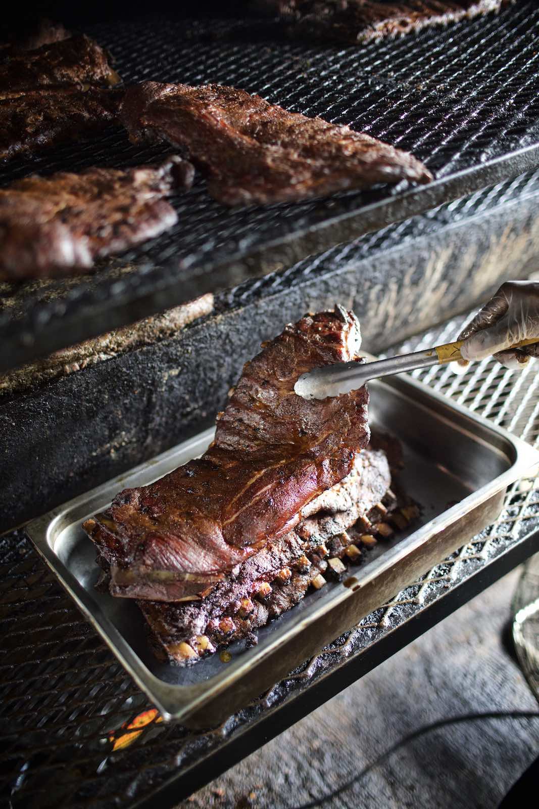 Jody Horton Photography - Racks of ribs cooking in the smoker. 
