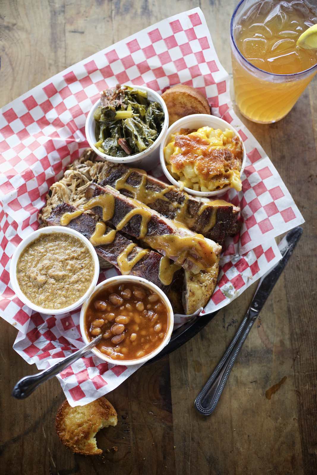 Jody Horton Photography - Barbecue plate with beans and collards on checkered parchment. 