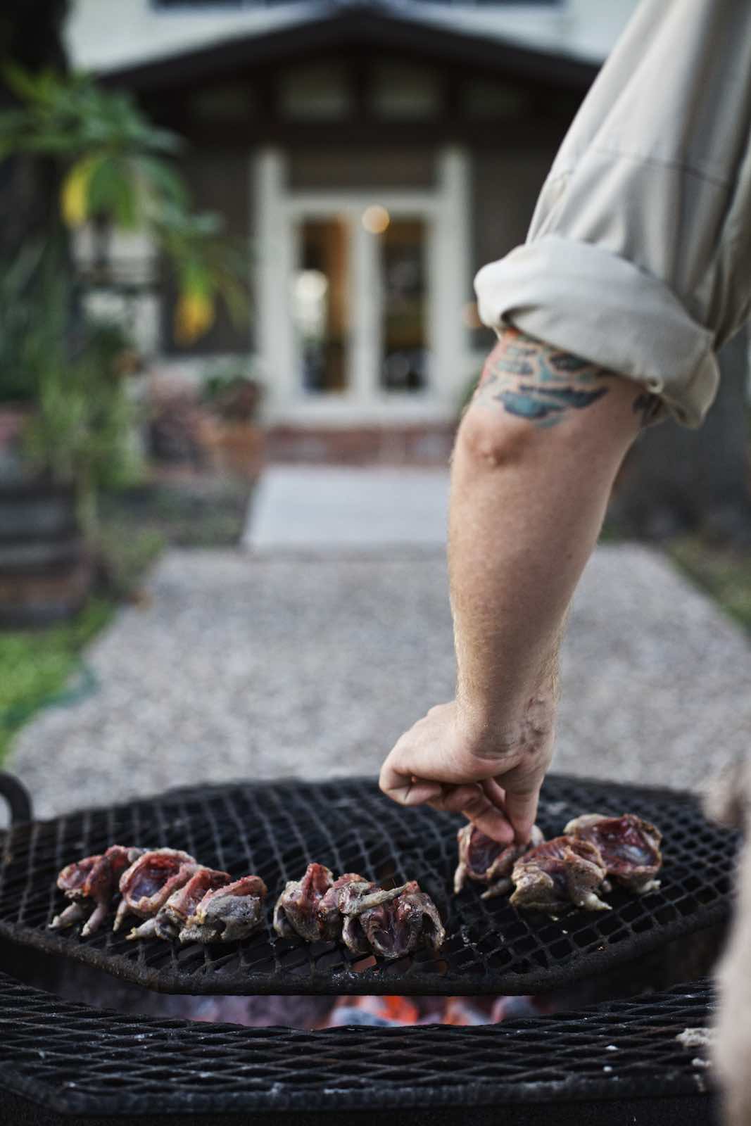 Jody Horton Photography - Chef Jesse Griffiths cooking doves on a charcoal grill. 