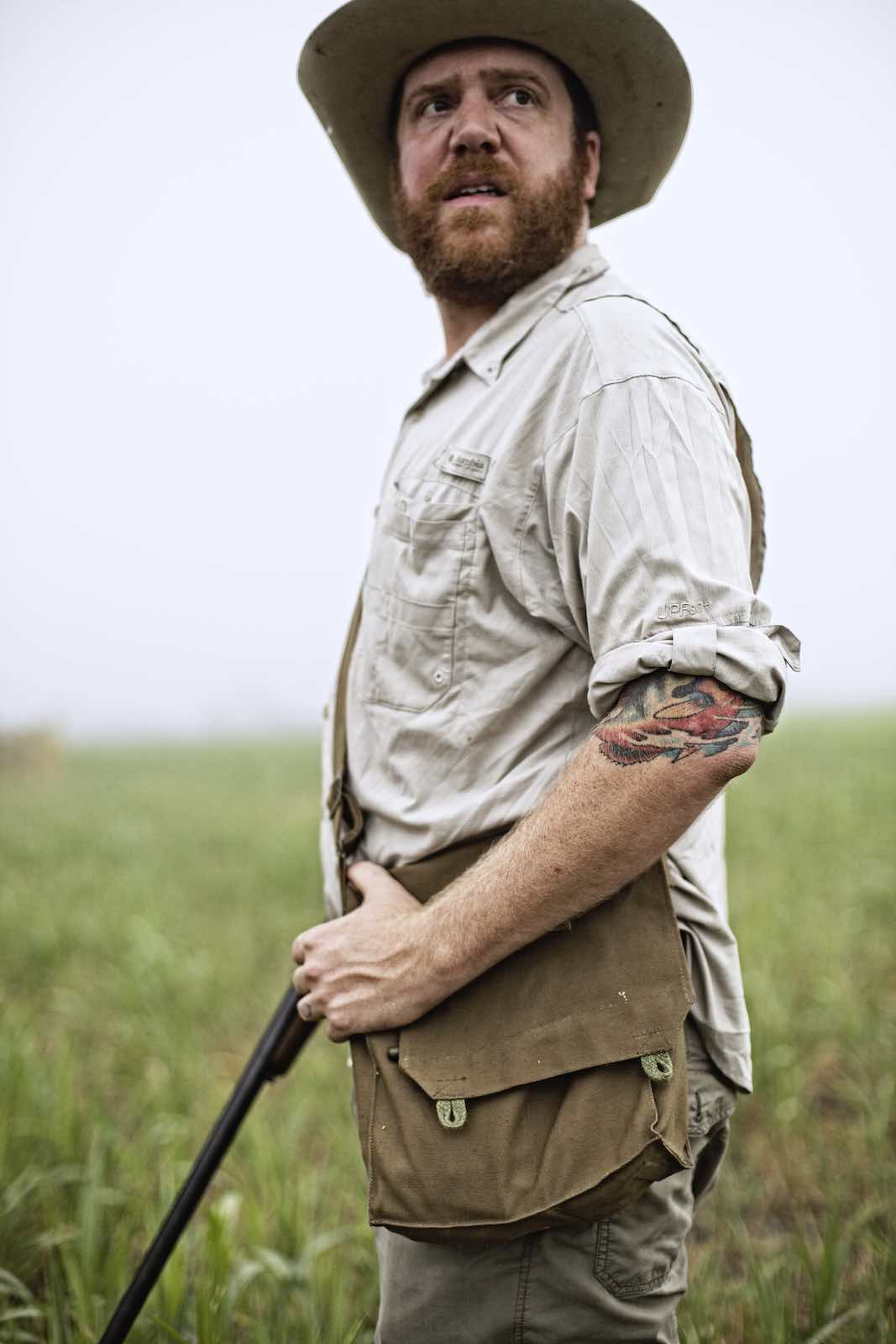 Jody Horton Photography - Chef Jesse standing with his rifle. 