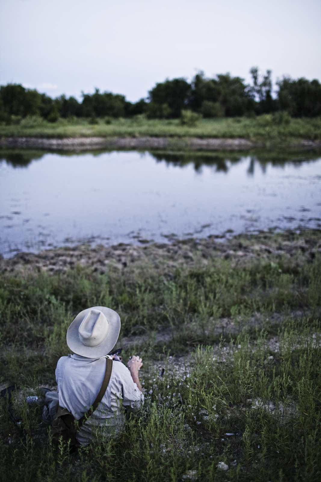 Jody Horton Photography - Chef Jesse sitting on a riverbank. 