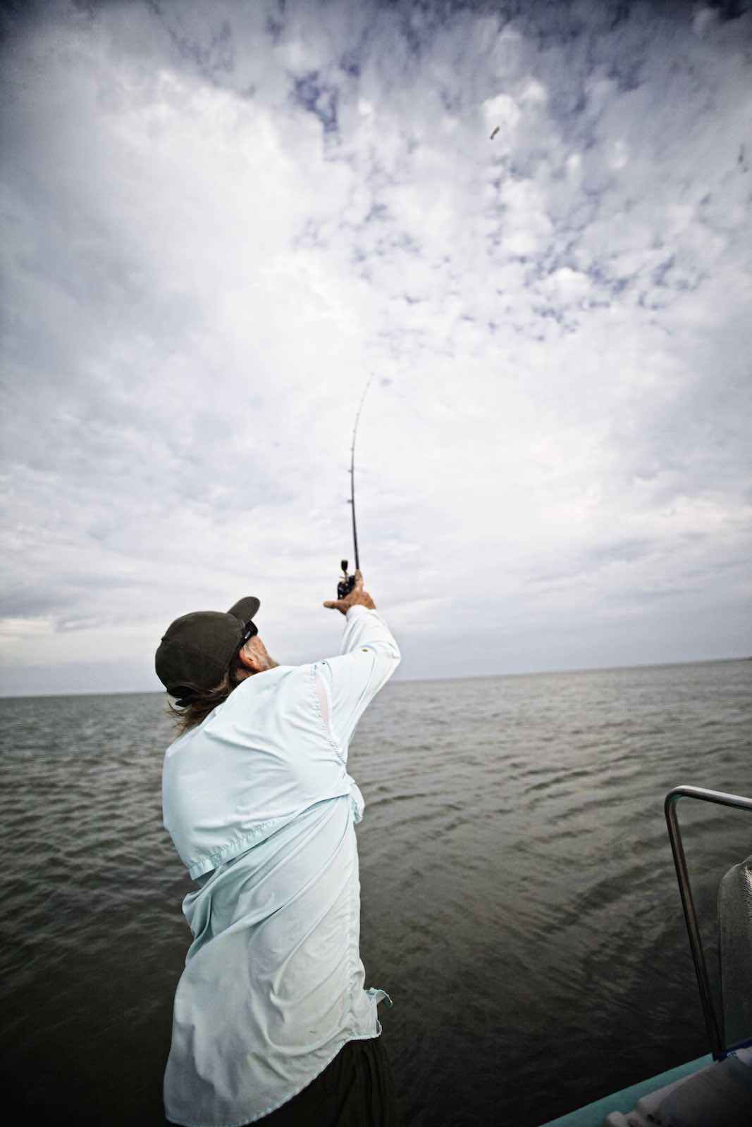 Jody Horton Photography - Fisherman casting a line off fishing boat.