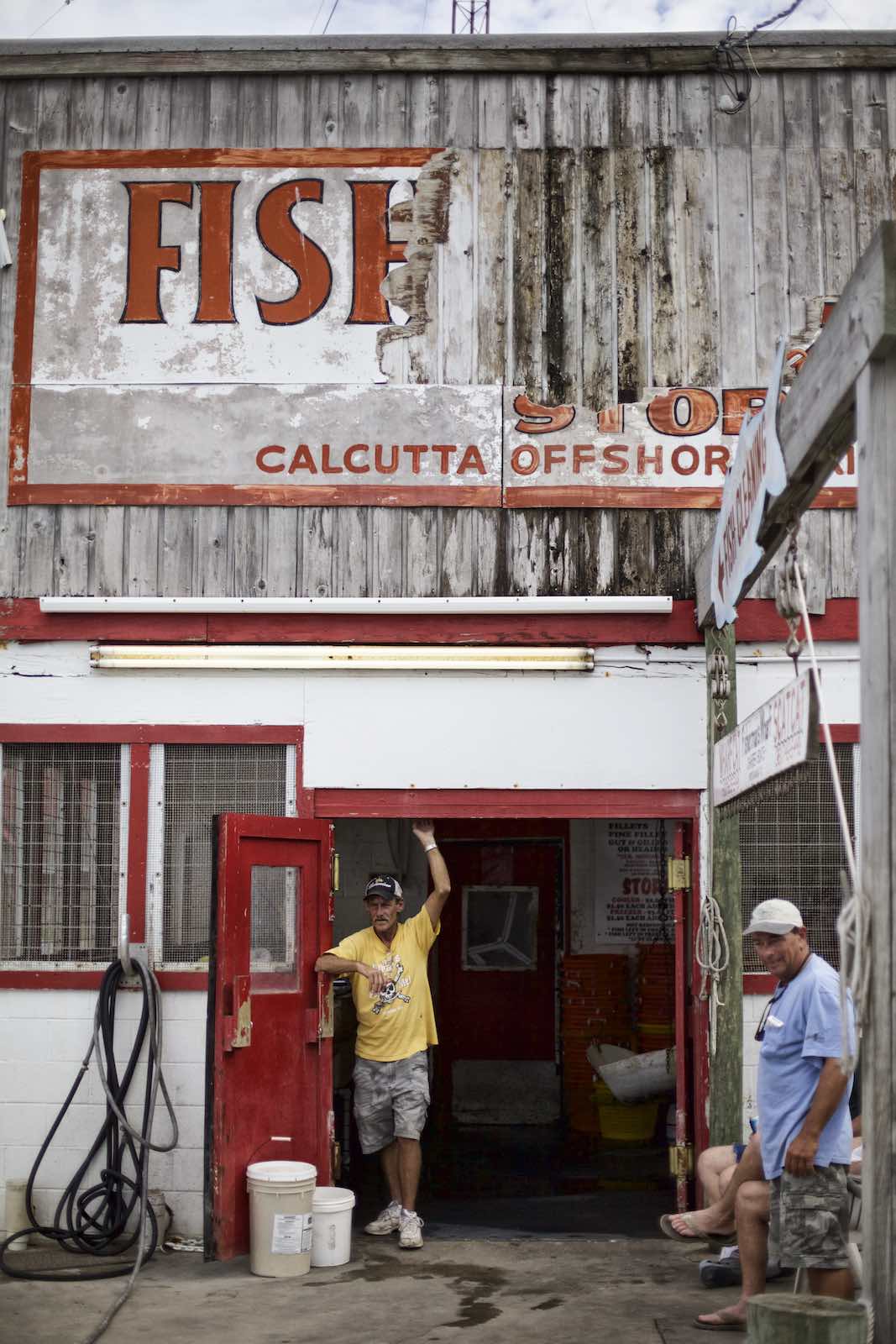 Jody Horton Photography - Fishermen standing outside store. 