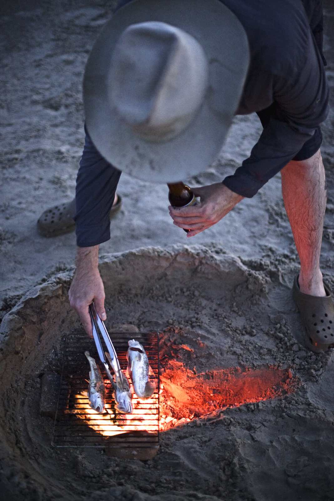 Jody Horton Photography - Chef Jesse grilled fish on a fire made in the sand. 