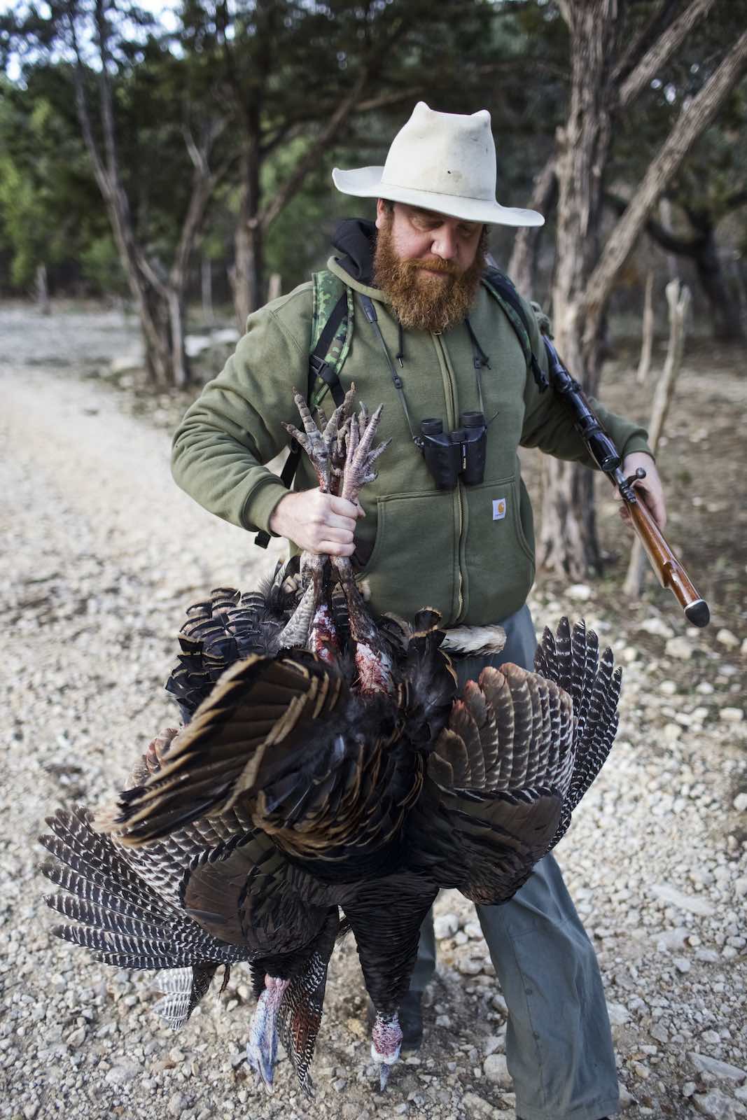 Jody Horton Photography - Chef Jesse carrying turkeys by the feet. 