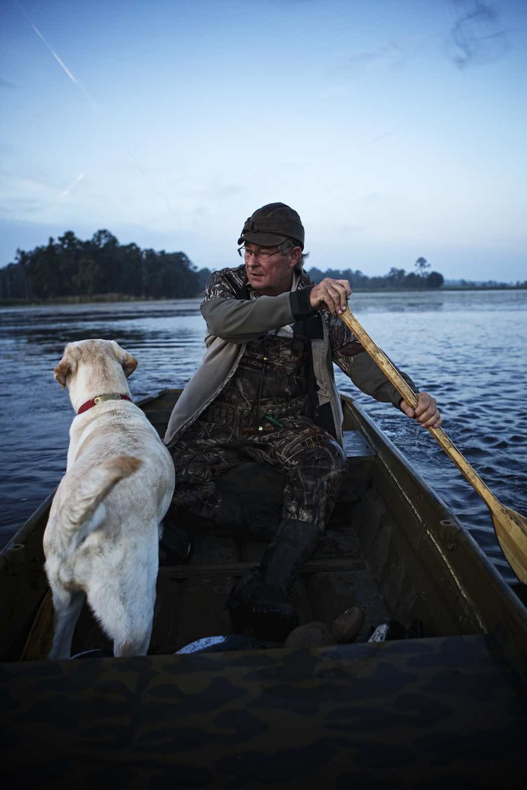 Jody Horton Photography - Hunter and his dog rowing through the water in the evening. 