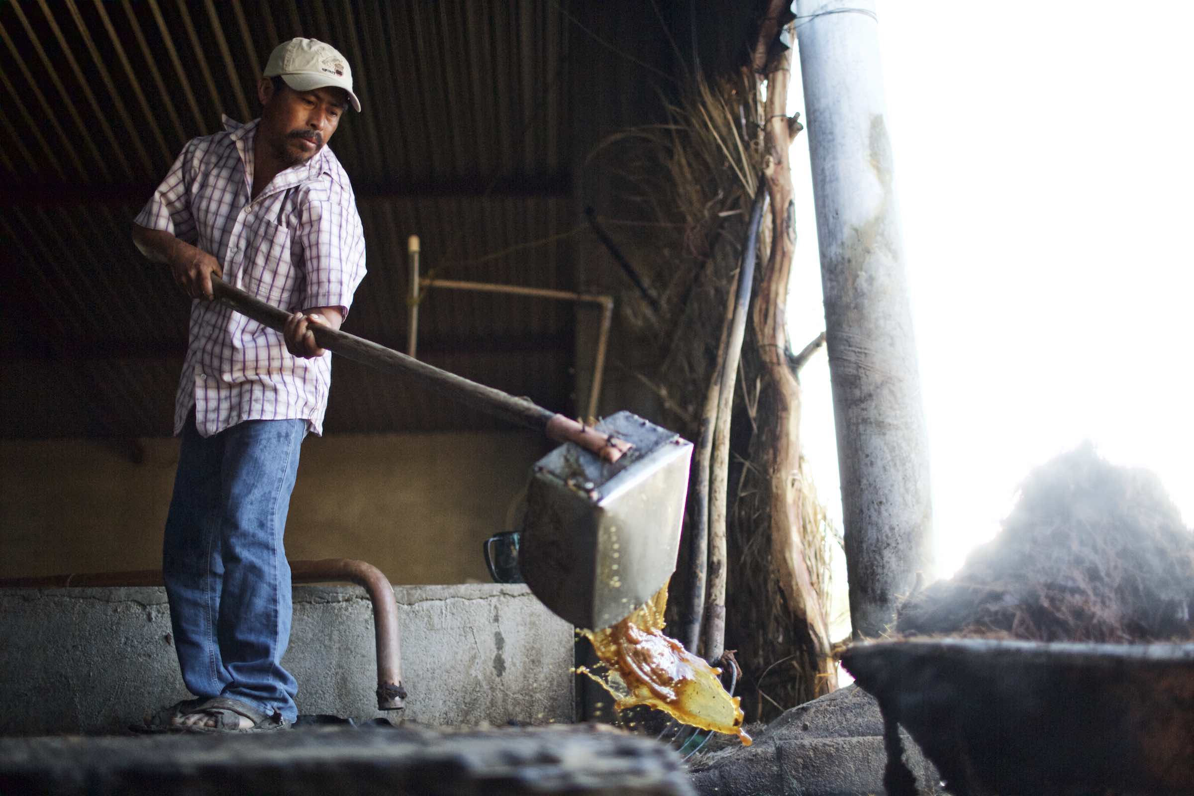 Jody Horton Photography - Farmer dumping liquid during production. 