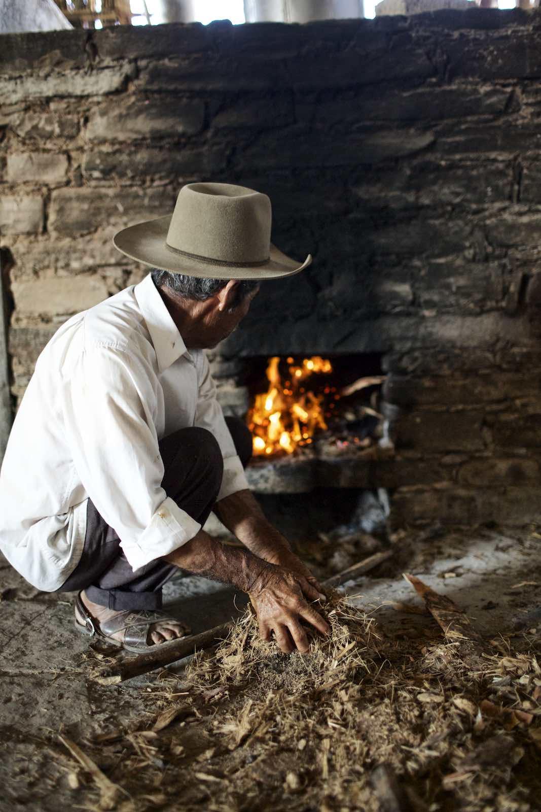 Jody Horton Photography - Farmer building a small fire.