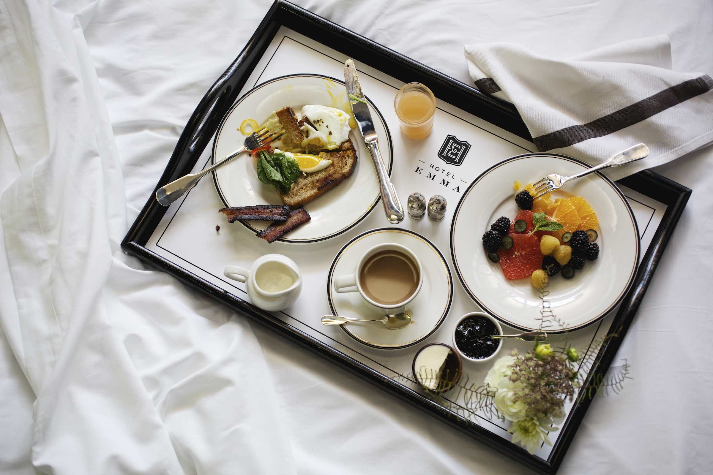 Jody Horton Photography - Room service breakfast spread served on white bedding. 