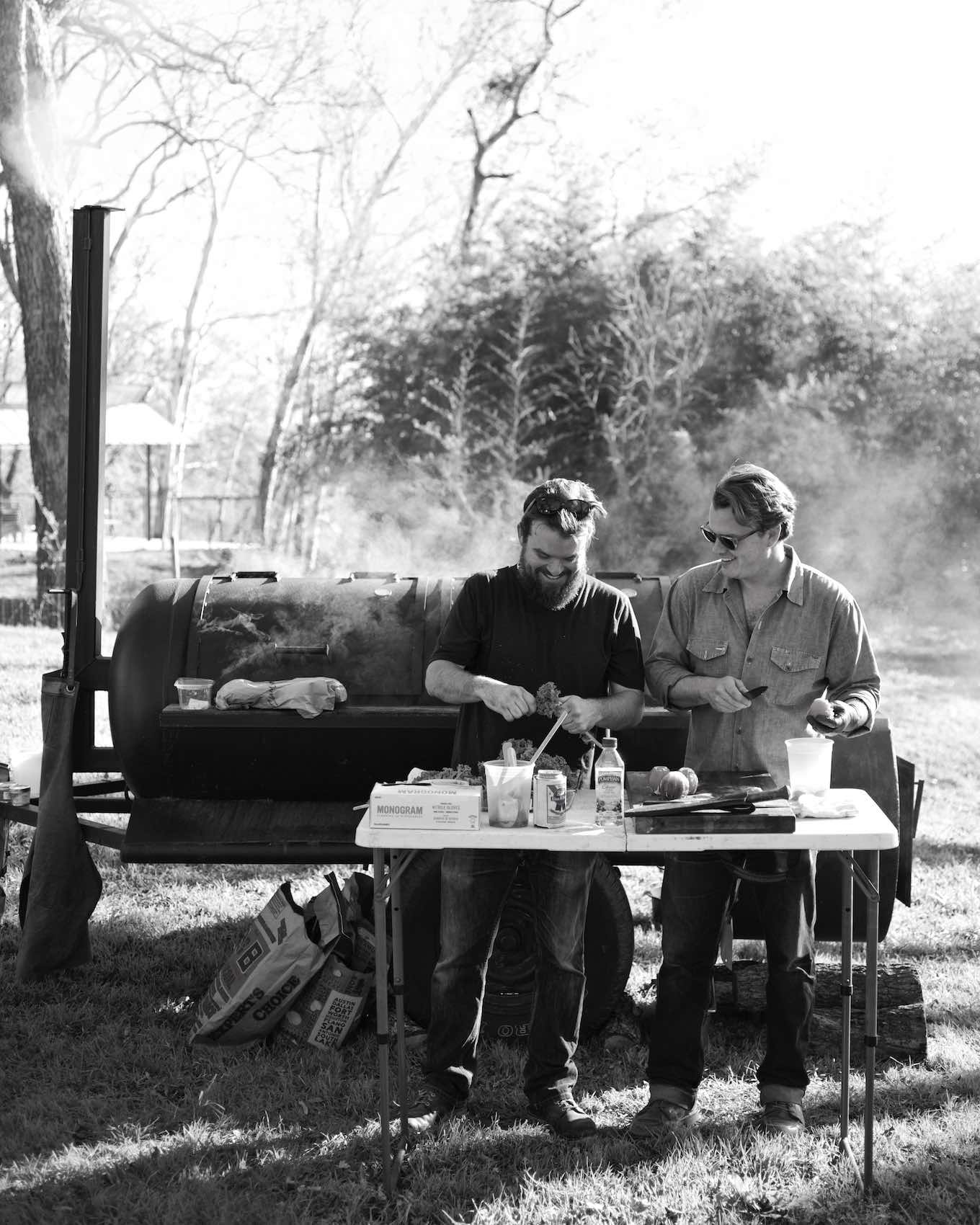 Jody Horton Photography - Chefs prepping ingredients in front of outdoor smoker, shot in B&W. 