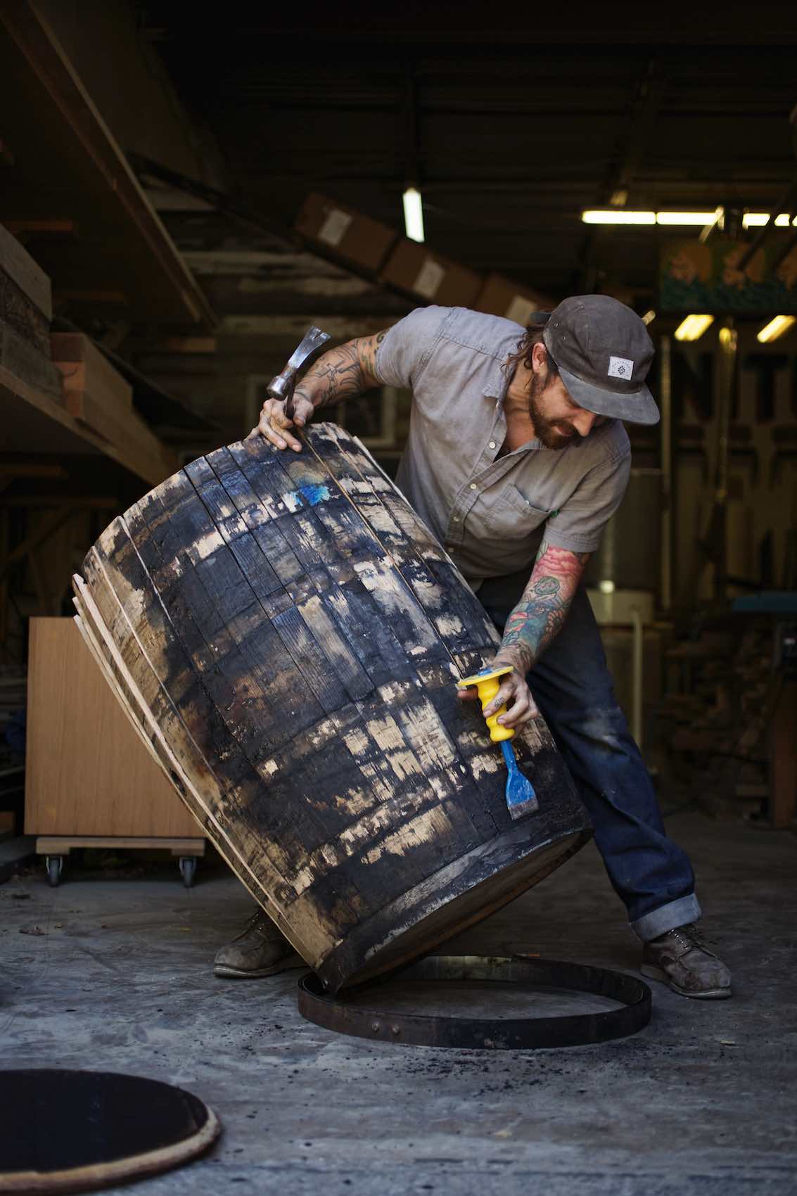 Jody Horton Photography - Man breaking down wood barrel. 