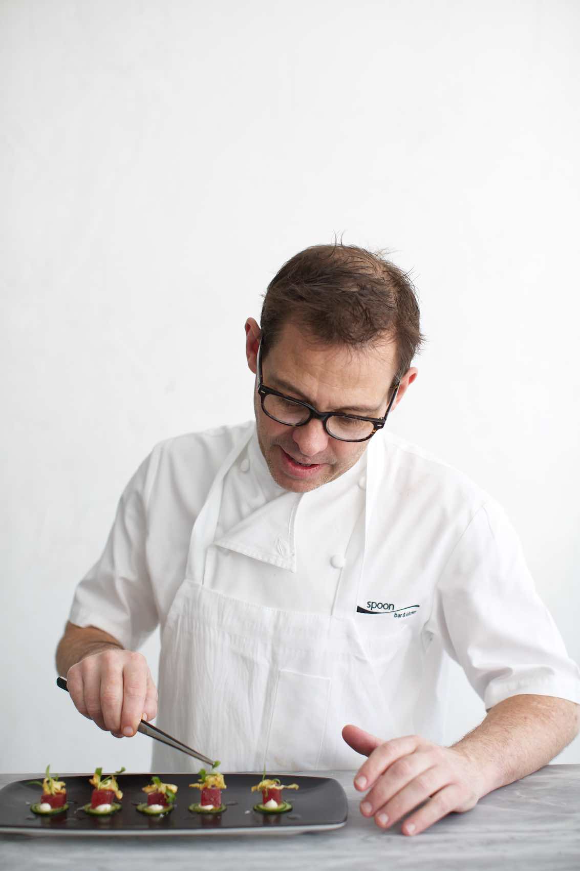 Jody Horton Photography - Chef in uniform plating a dish.