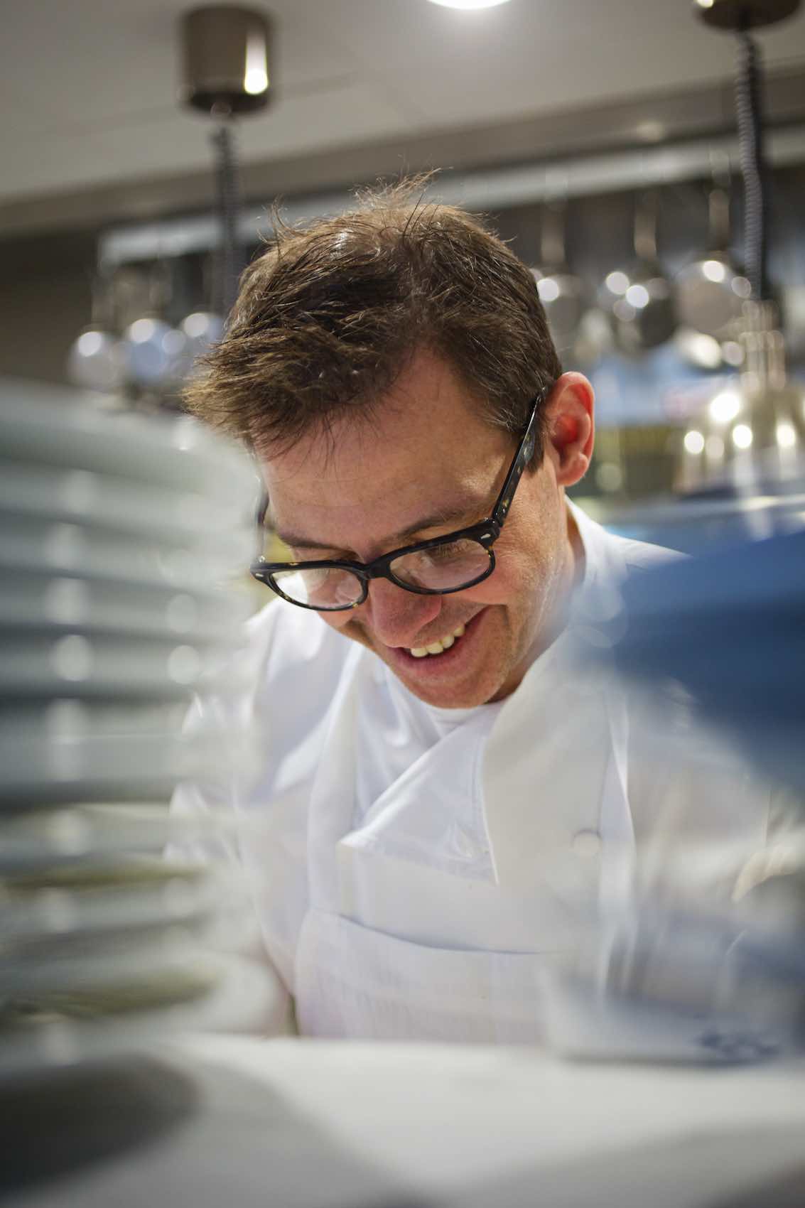 Jody Horton Photography - Chef smiling while working in the kitchen.