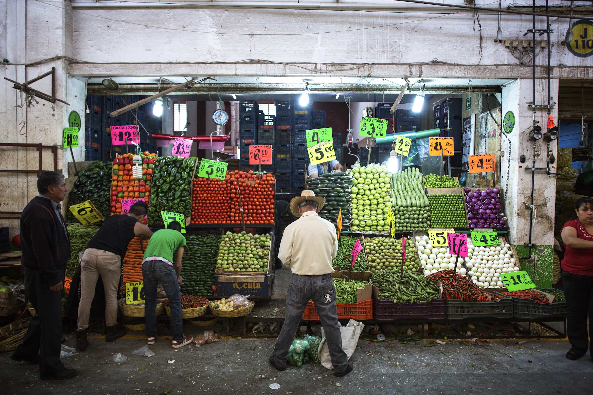Jody Horton Photography - Patrons buying colorful produce from a street vendor.