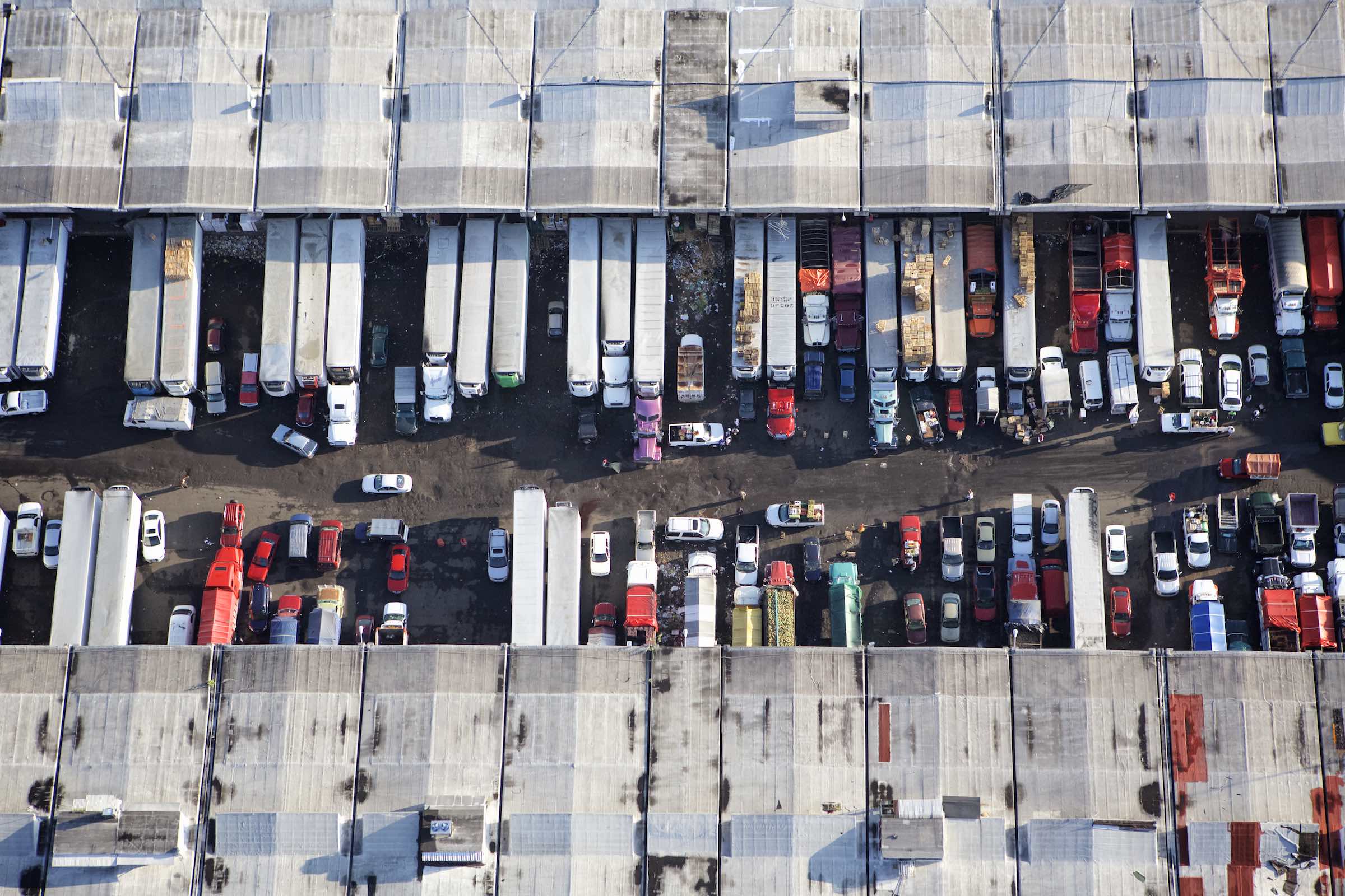 Jody Horton Photography - Trucks unloading goods at the food market in Mexico. 