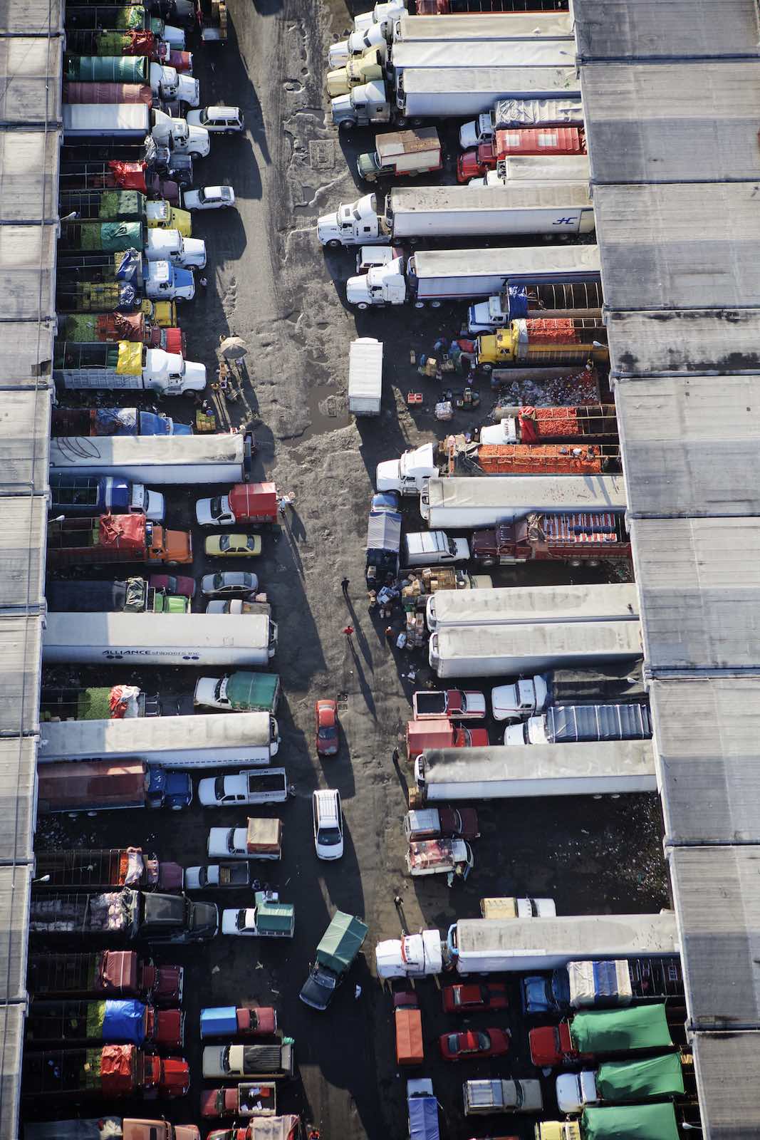 Jody Horton Photography - Trucks and cars hauling goods into the food market. 