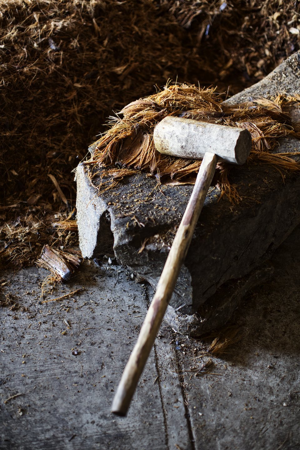 Wooden mallet and agave fibers during mezcal production. 