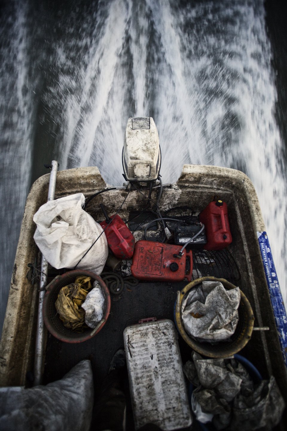 Motor boat carrying  fishing gear on the water. 