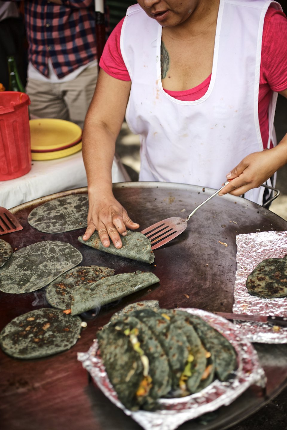 Chef preparing blue corn tacos on a Plancha. 