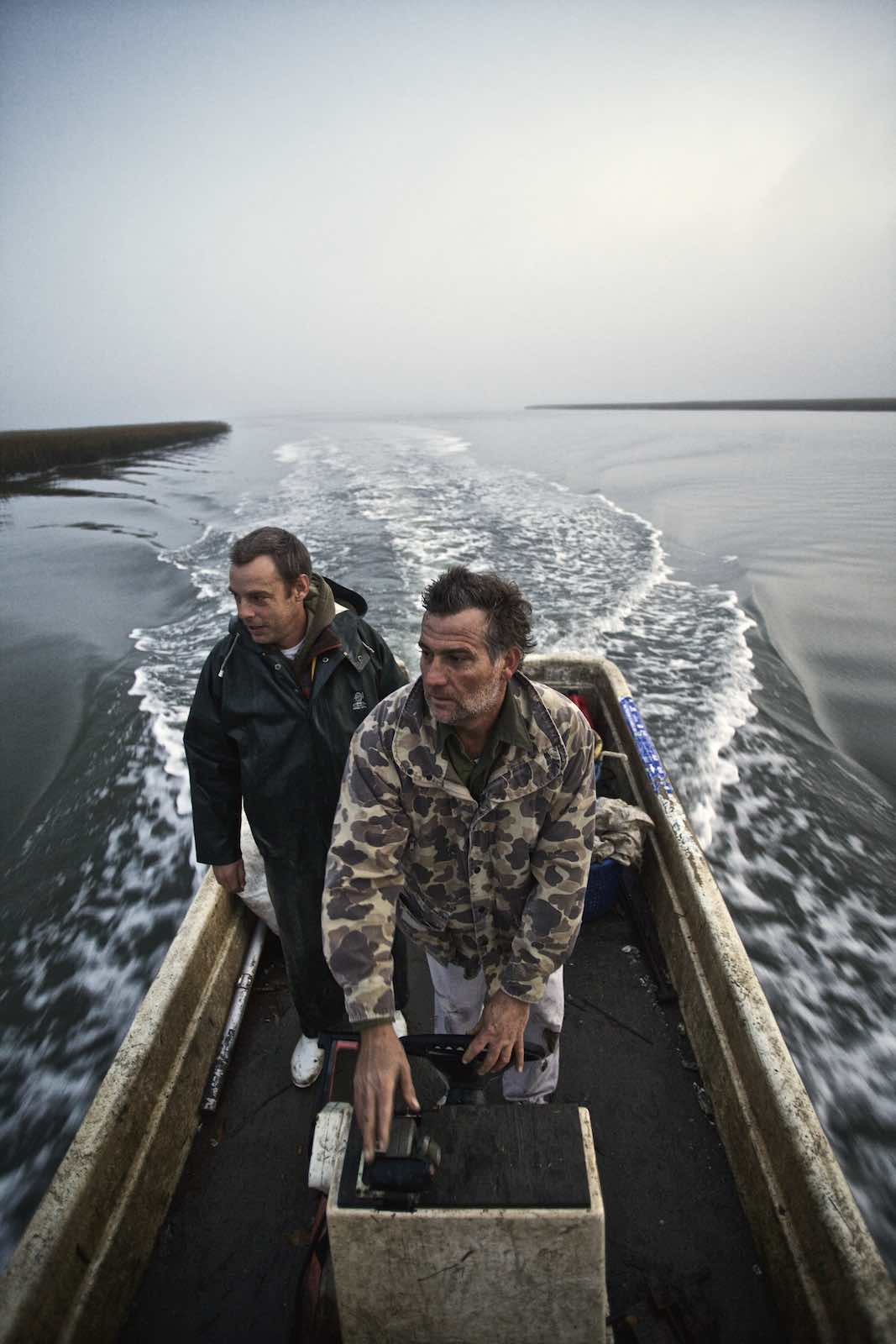 Jody Horton Photography - Fishermen guiding their boat across dark waters. 