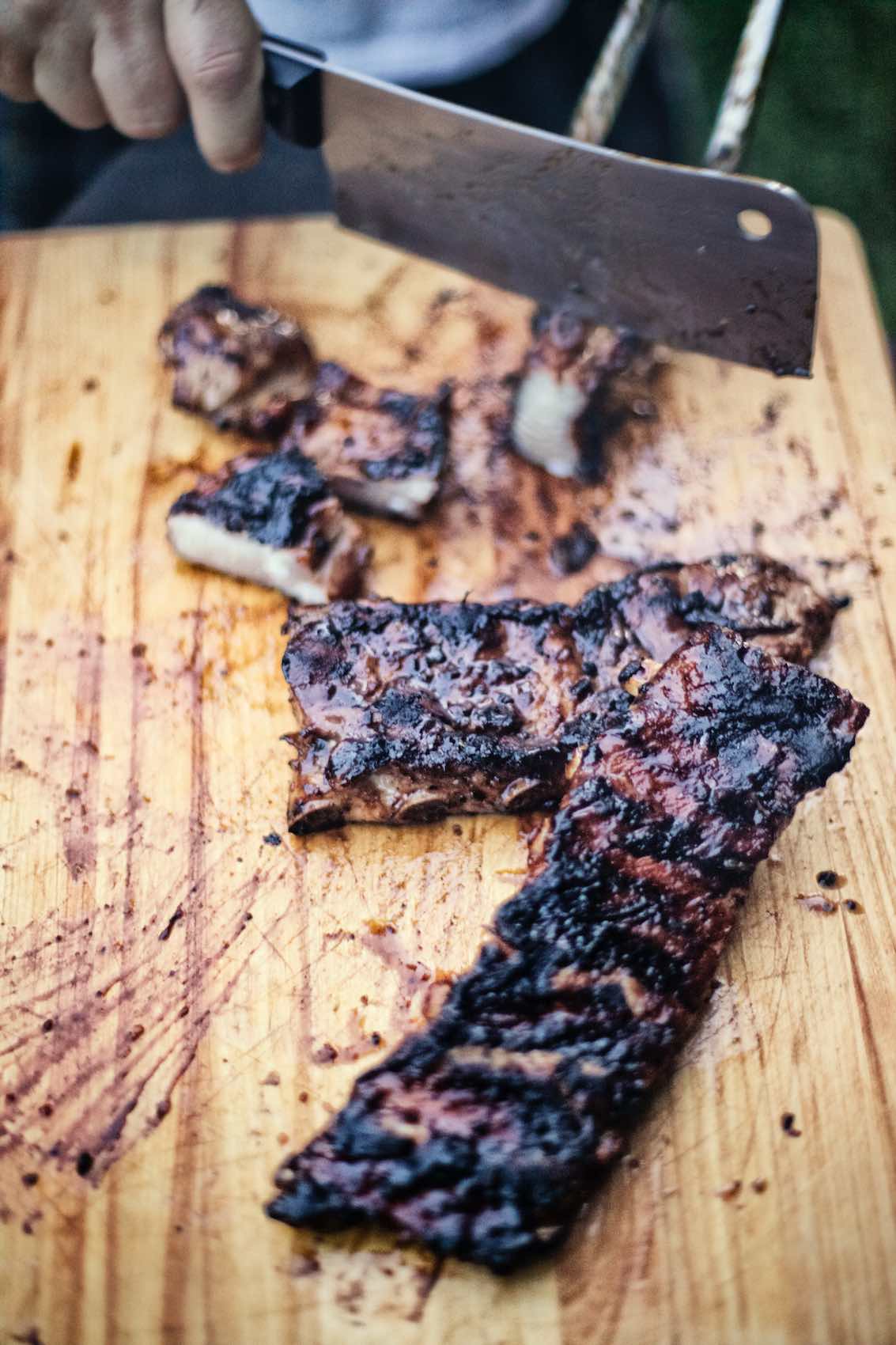 Jody Horton Photography - Barbecued ribs sliced on wood cutting board.
