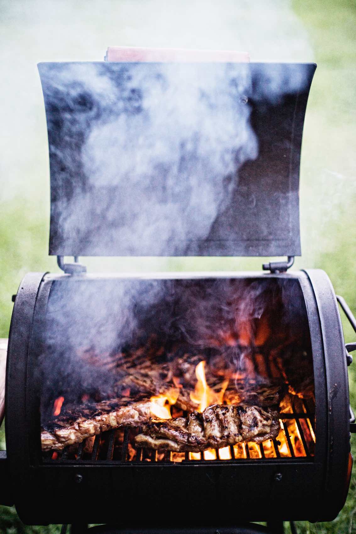 Jody Horton Photography - Meats cooking in small, outdoor smoker. 