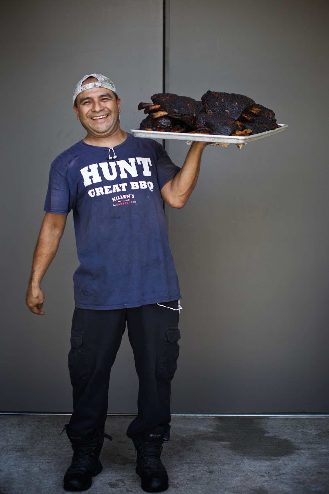 Jody Horton Photography - Man proudly holding tray of smoked meats. 
