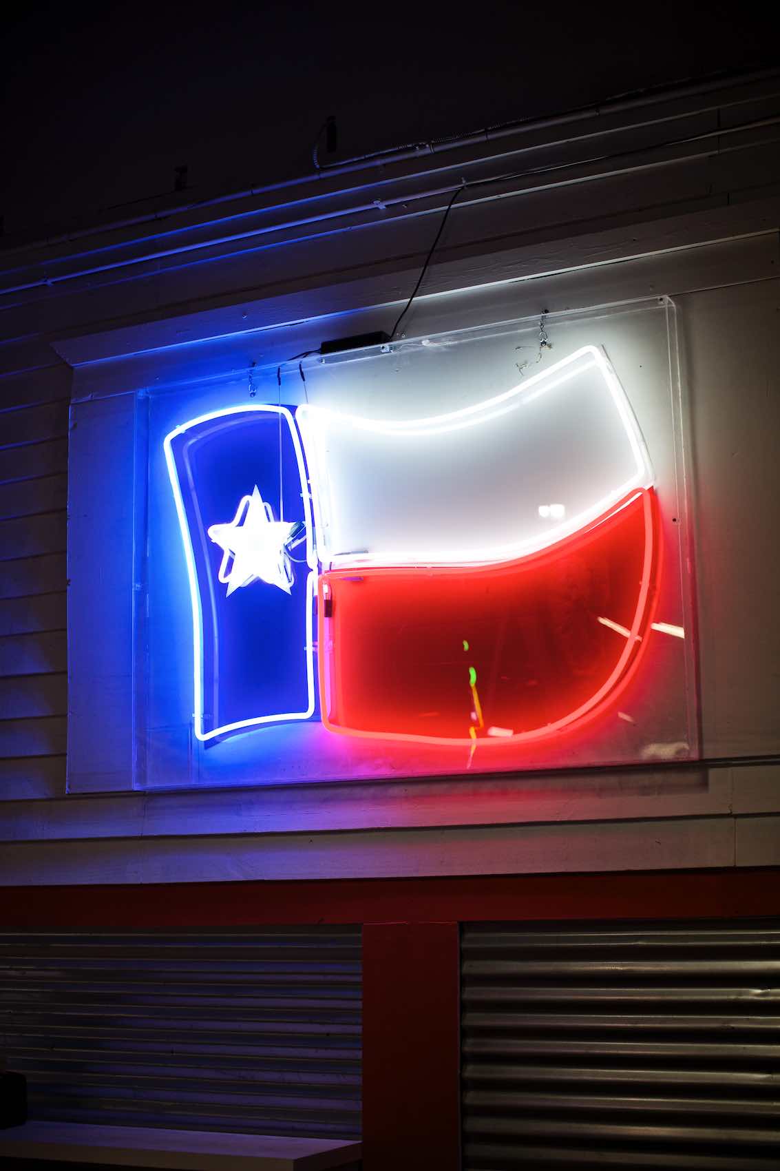 Jody Horton Photography - Texas flag neon light outside store front. 
