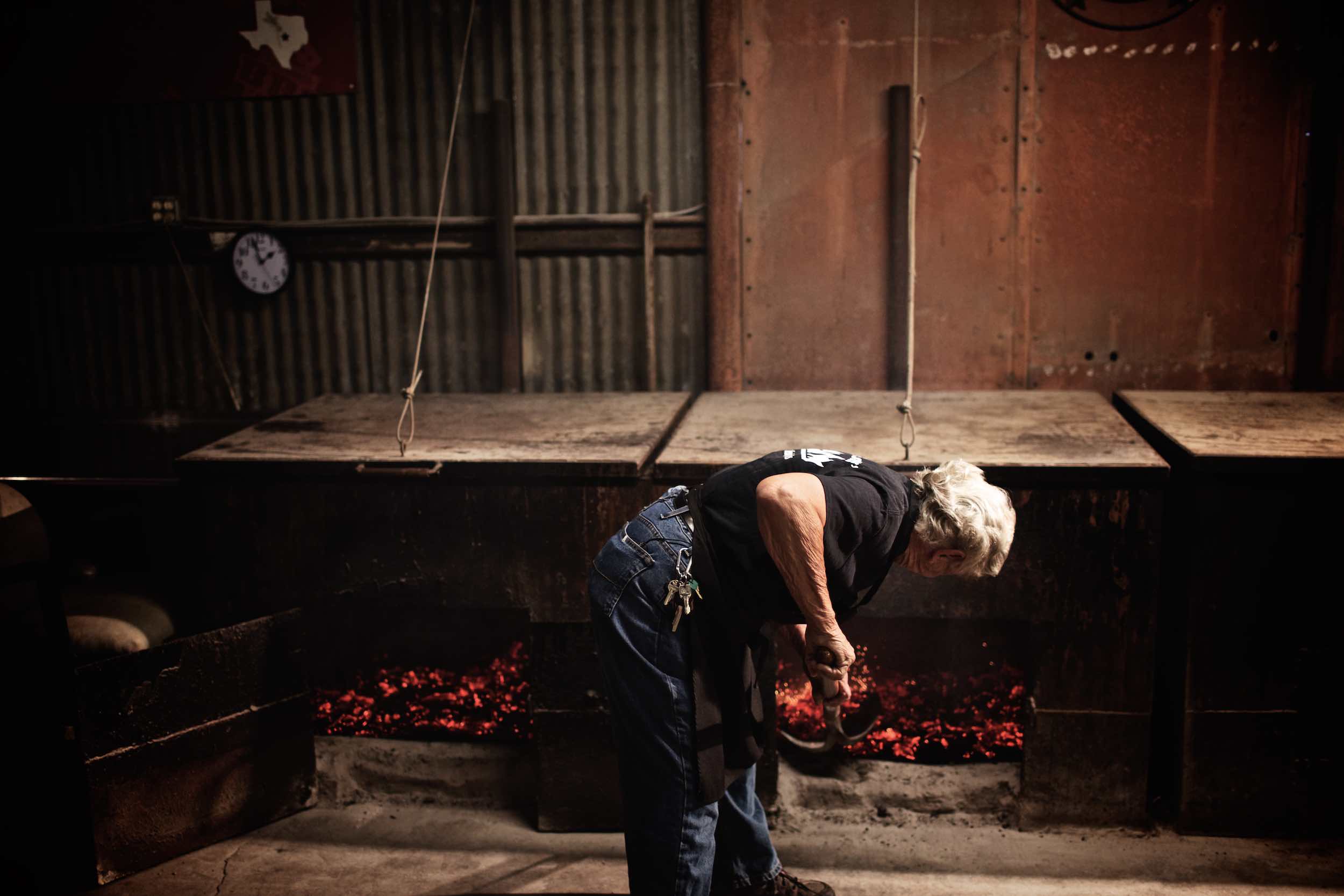 Jody Horton Photography - Pit master shoveling hot coals.