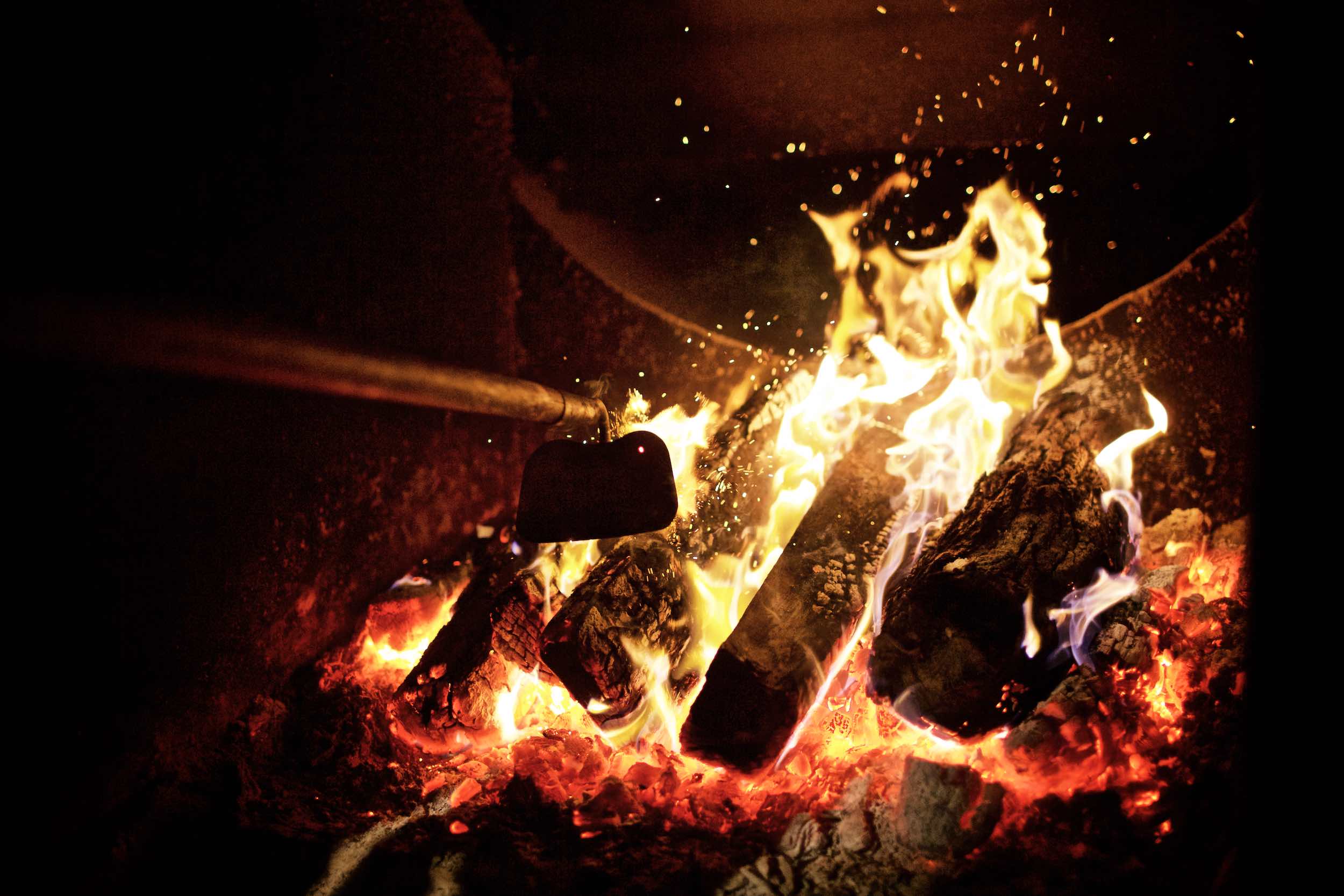 Jody Horton Photography - Stoking a wood fire. 