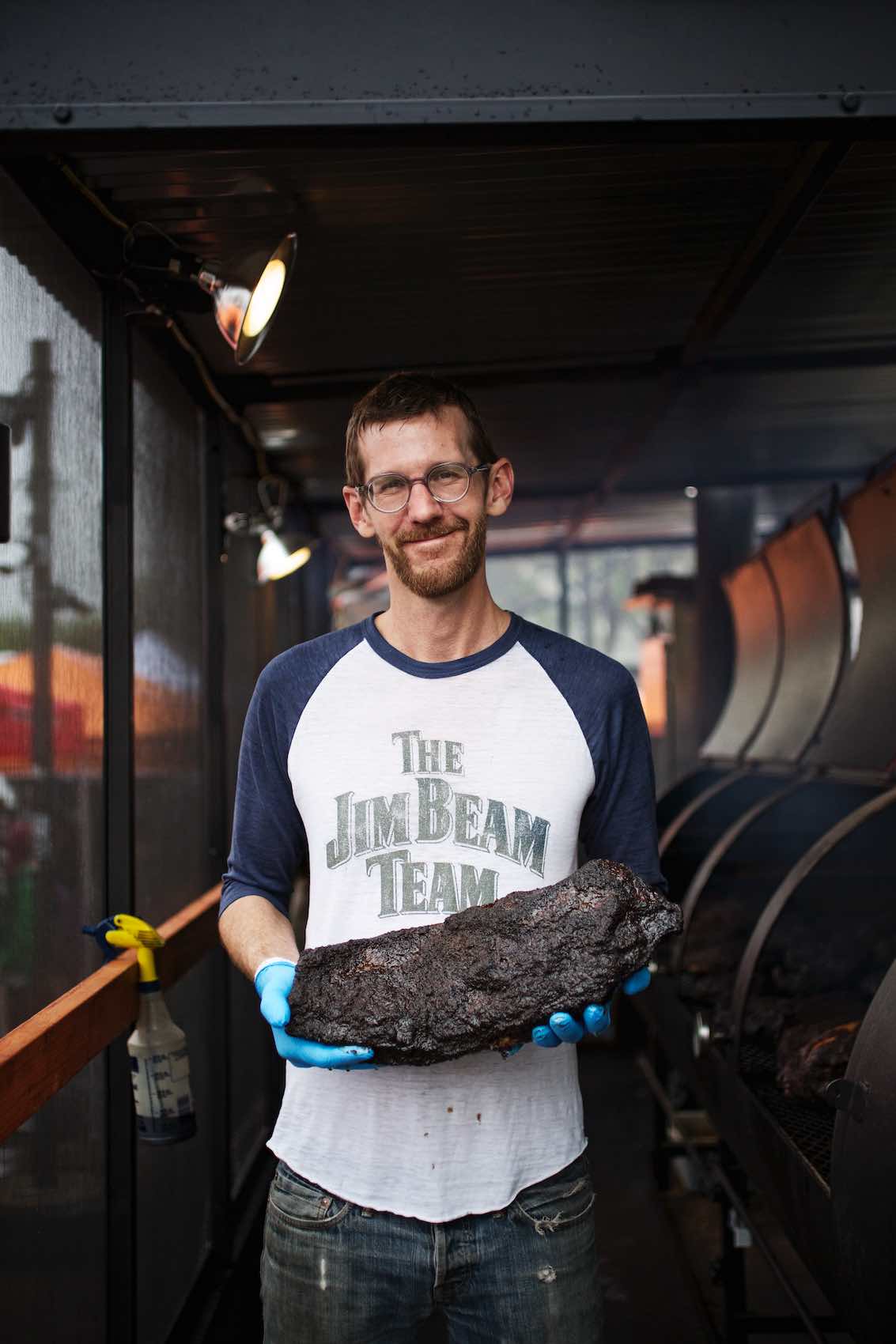 Jody Horton Photography - Pit master presenting blackened slab of meat. 