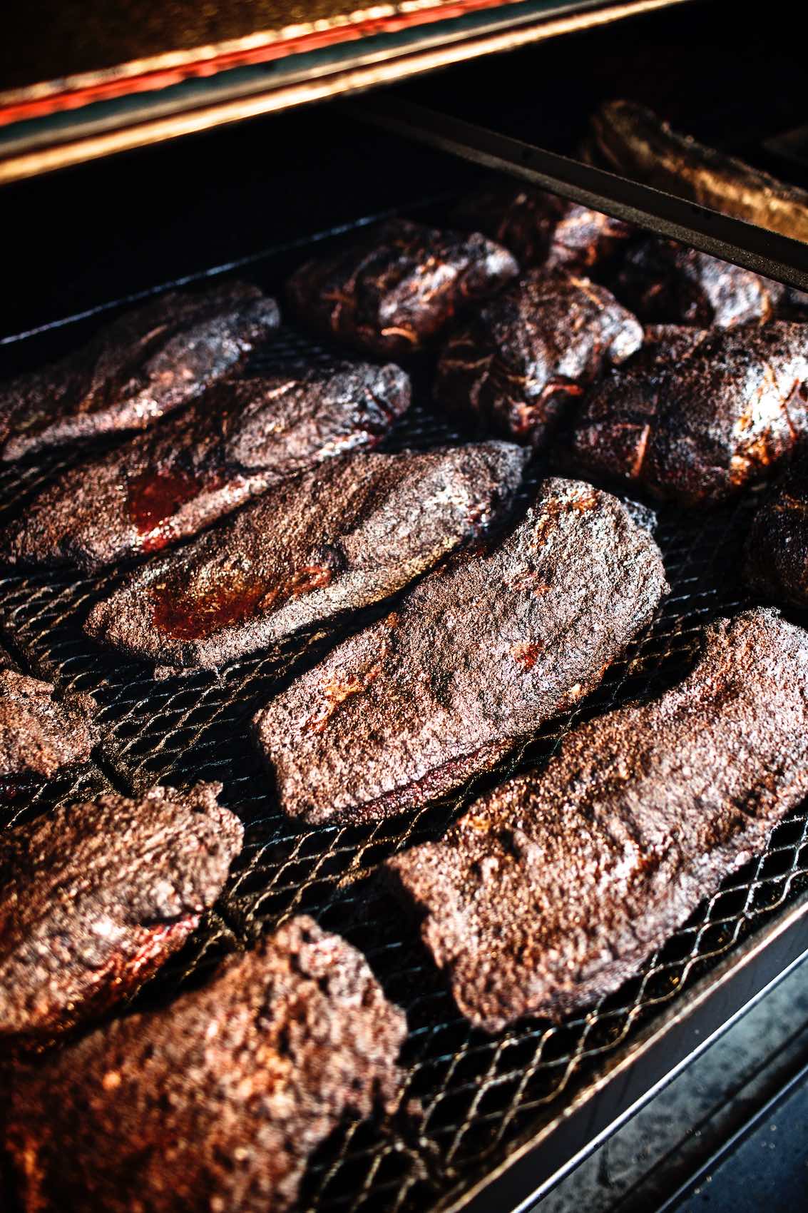 Jody Horton Photography - Barbecued meats cooking on grill. 