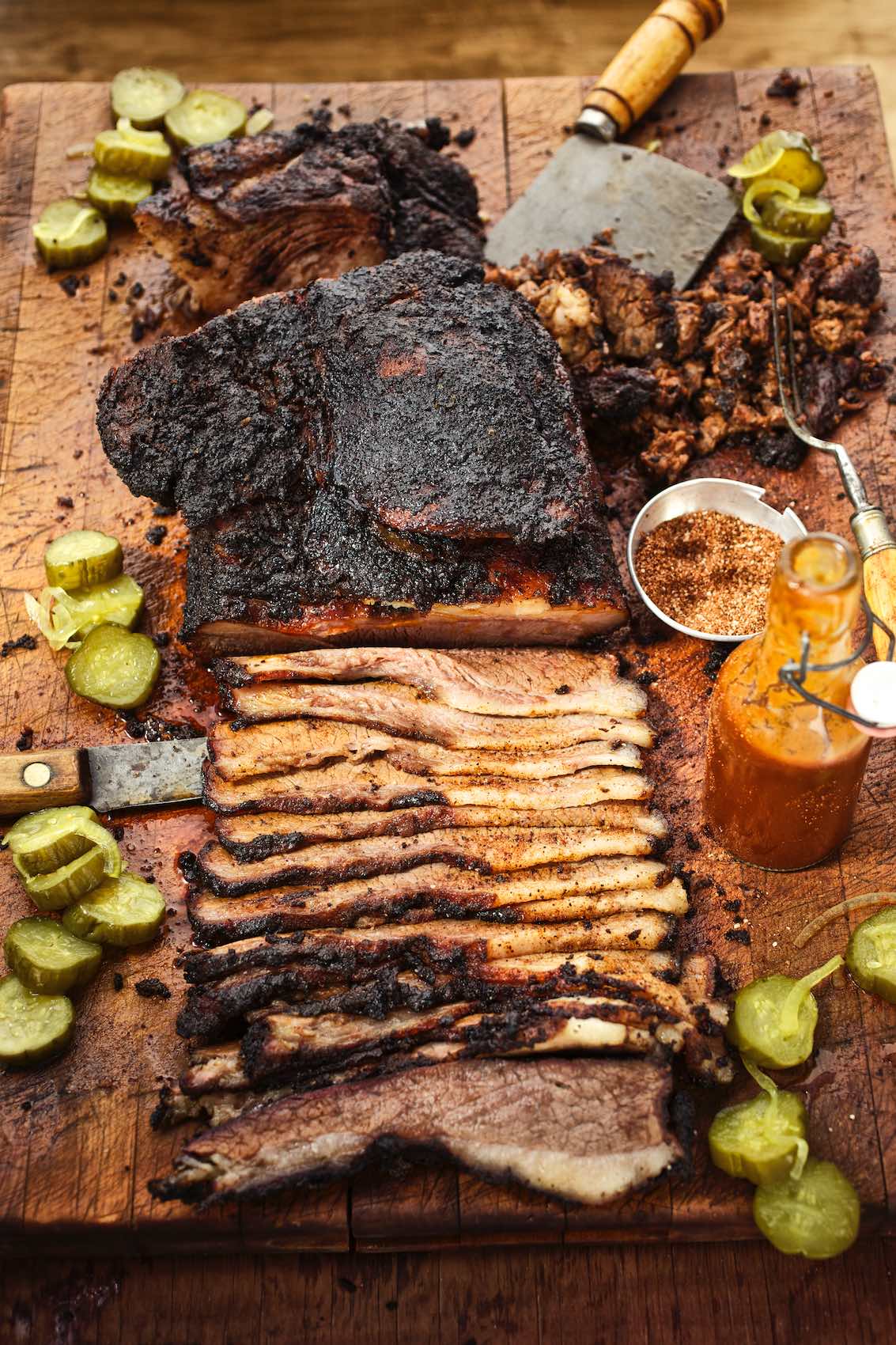 Jody Horton Photography - Sliced barbecue brisket, hot sauce, and bread and butter pickles.
