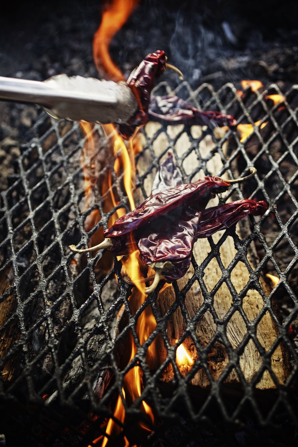Jody Horton Photography - Chilies charring on a wood fire.