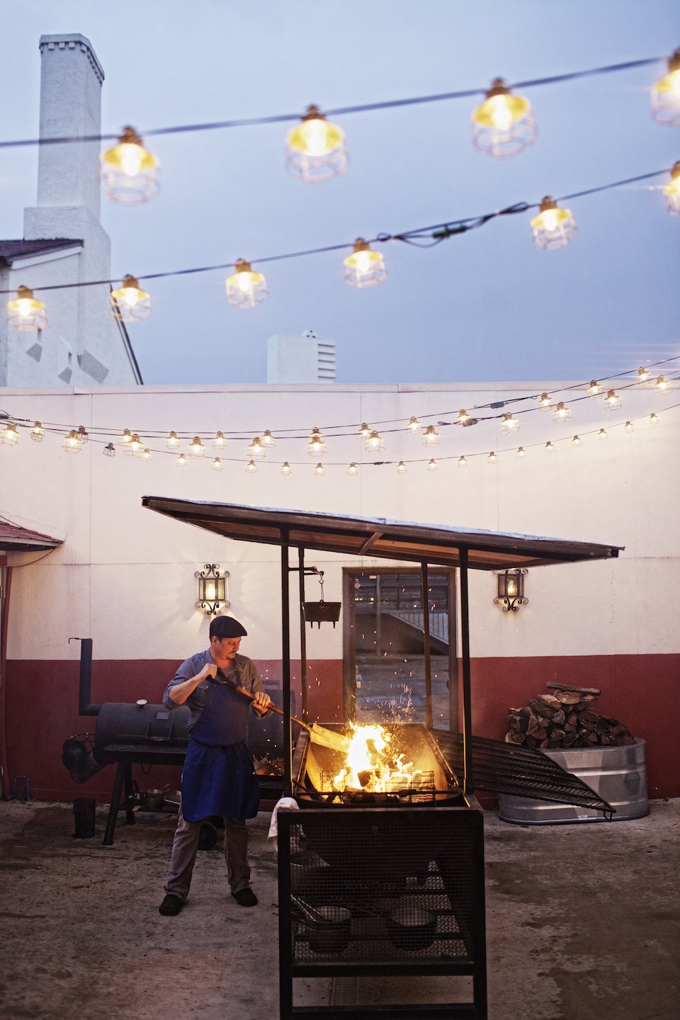 Jody Horton Photography - Chef Tim Byres stoking an outdoor fire.